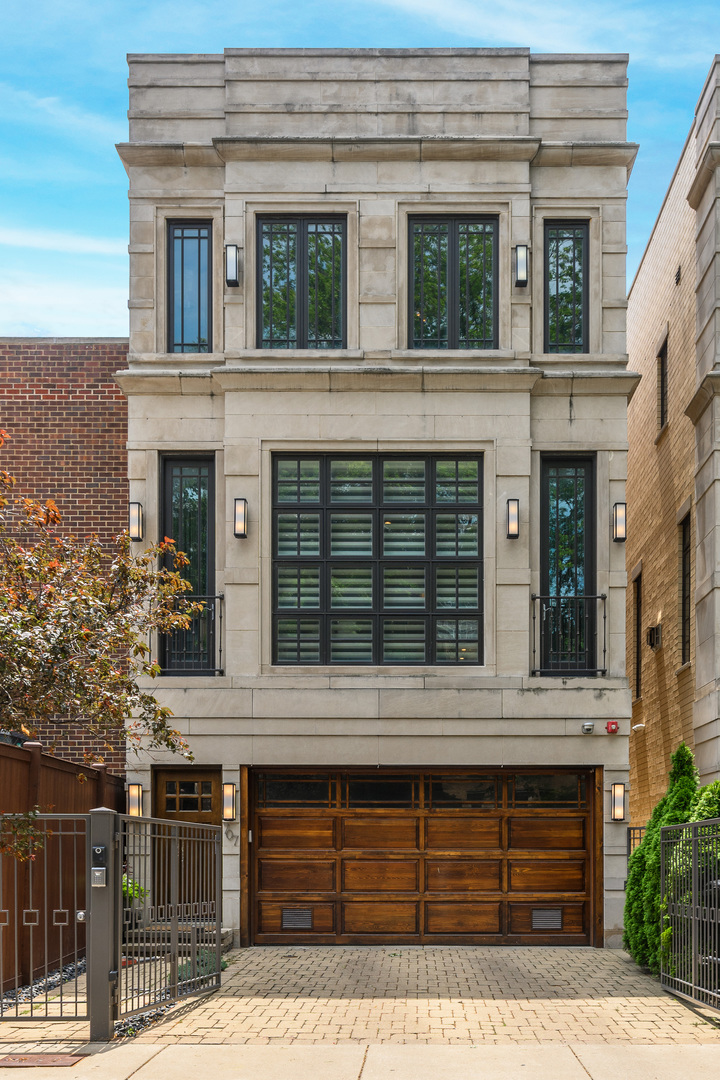 Welcome to 707 W Gordon Terrace, a striking single-family residence that blends timeless elegance with modern luxury, just steps from Lake Michigan in the heart of Buena Park. Step inside to find a sun-drenched main level with soaring ceilings, custom millwork, and beautiful hardwood floors. The living room is centered around a sleek gas fireplace and oversized windows, creating an inviting space that flows seamlessly into the dining area, highlighted by wainscoting and a coffered ceiling. The chef's kitchen is a true showstopper, featuring a La Cornue range with pot filler, Miele built-in refrigerator, freezer, espresso machine, and microwave, along with granite countertops, a warming drawer, wine fridge, and expansive island. From here, step onto one of two balconies overlooking your private landscaped backyard oasis, complete with a bluestone patio and outdoor fireplace. The third level features a luxurious primary suite with dual walk-in closets, a private balcony, and a spa-like bath with steam shower, soaking tub, and double vanity. Two additional bedrooms with a Jack & Jill bath and a full laundry room complete this floor. The top level boasts a rooftop deck designed for effortless entertaining, complete with a wet bar, beverage center, and dishwasher, perfectly positioned to maximize indoor-outdoor living. The lower level is designed for relaxation with a family/media room featuring a 96" projector screen and 7.1 surround sound, a fourth bedroom/office with custom built-ins, a temperature-controlled wine room, wet bar, radiant heated floors, and a full bath. French doors open to the backyard, creating a seamless extension of your living space. Additional highlights include a two-car attached garage with extra parking for two, central vac, security system, multiple fireplaces, and custom designer details throughout. Situated just steps from the lakefront, Montrose Harbor, and vibrant neighborhood dining and shopping, this home offers a rare opportunity to own a private retreat in one of Chicago's most coveted locations.