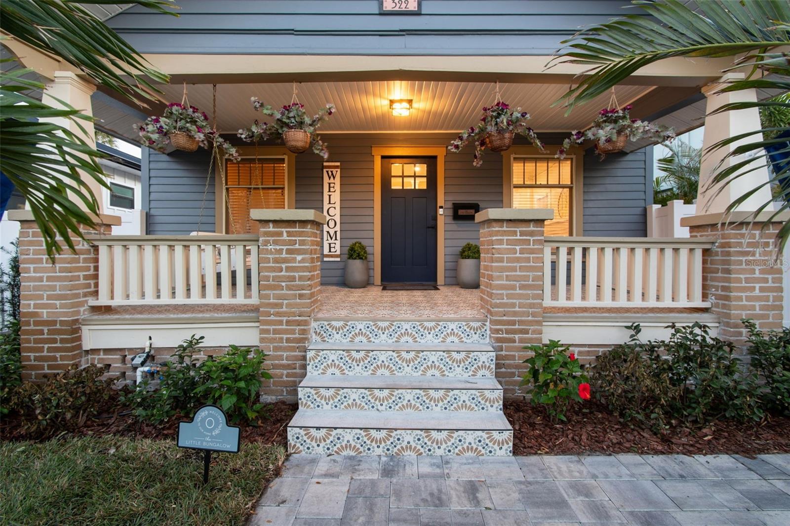 Welcome to this charming 1920's Craftsman Bungalow beautifully renovated and aptly named "The Little Bungalow". Ideally located in the heart of the Historic Old Northeast, this 1128 Sq Ft 2 bedroom/1 bath Bungalow is just steps away from Downtown St Petersburg, Vinoy Park and the vibrant 4th Street Corridor.  Recently completely renovated inside and out, offering the ease and enjoyment of a turn- key, move in ready abode.Step up onto the large front porch, classically finished with stunning ceramic tile featuring a vintage “bloom” pattern—the perfect spot to relax and unwind. Inside, the home opens to a bright and inviting living room with a white brick fireplace and built-in shelving that subtly divides the living and dining spaces. Hardwood floors run throughout, complemented by a unique display ledge ¾ of the way up the wall that wraps around both rooms, adding architectural charm and character. The dining area features a beautiful white built-in shelf with drawers, plus a wall mirror that enhances the space and light.Both bedrooms are nearly equal in size, each offering a nicely sized closet with stylish barn doors. The hallway includes an enclosed stackable washer and dryer along with additional built-in white cabinetry for extra storage.The bathroom is a showstopper—finished with white subway tile, striking black fixtures and mirror, and vintage black-and-white bloom-pattern ceramic tile flooring. The shower boasts white tile, a black inset shelf, black ceramic flooring, a vertical octagon-pattern accent strip, and a rainfall showerhead with a side sprayer for a spa-like experience.The kitchen is equally impressive, featuring gray cabinetry, stainless steel appliances, including a dishwasher, an extra built-in wine cooler, and gorgeous white granite countertops. The peninsula's countertop is perfect for barstools, and the eat-in kitchen is surrounded by floor-to-ceiling windows, flooding the space with natural light.  In addition, off the kitchen area and bar, is a sunroom, surrounded by windows, overlooking the well-manicured, landscaped backyard,  and full of natural light, a perfect space for meals, home office or relaxation space. Perfect for nights at home or entertaining guests.Outside, you’ll find an outdoor oasis that’s truly rare for downtown living with its recently done professional landscaping! This private sanctuary is perfect for entertaining or relaxing and includes ceramic pavers,  a brand-new backyard deck, stepping stones, a new white vinyl fence, multi-layered lush tropical trees and flowers, and solar-lit walkways that create an incredible outdoor atmosphere.  Additional features include a 1-car garage with an extra washer and dryer; plus additional paved parking spaces located just behind the garage.The Little Bungalow blends timeless Old Northeast charm with thoughtful modern upgrades—all in an unbeatable location! Call and make The Little Bungalow your home today!*1128 Sq Ft*Roof Warranty*Professional Landscaping*Termite Warranty*Completely renovated inside and out*Outdoor Oasis*Turn Key- Move in Ready!