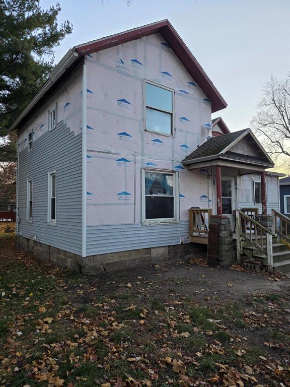 This home is a prime fixer-upper opportunity with solid bones, a spacious lot, and tons of potential. Featuring a classic two-story design with charming gables, a covered front porch, and a large side yard, the property offers the perfect canvas for renovation. Much of the exterior is already prepped with house wrap, making it ideal for someone ready to complete the siding and bring fresh curb appeal to the neighborhood. With mature trees, ample outdoor space, and a layout full of character, this property is perfect for investors, DIY renovators, or buyers looking to build equity by finishing a home to their own style. Once updated, it has the potential to become a standout property.