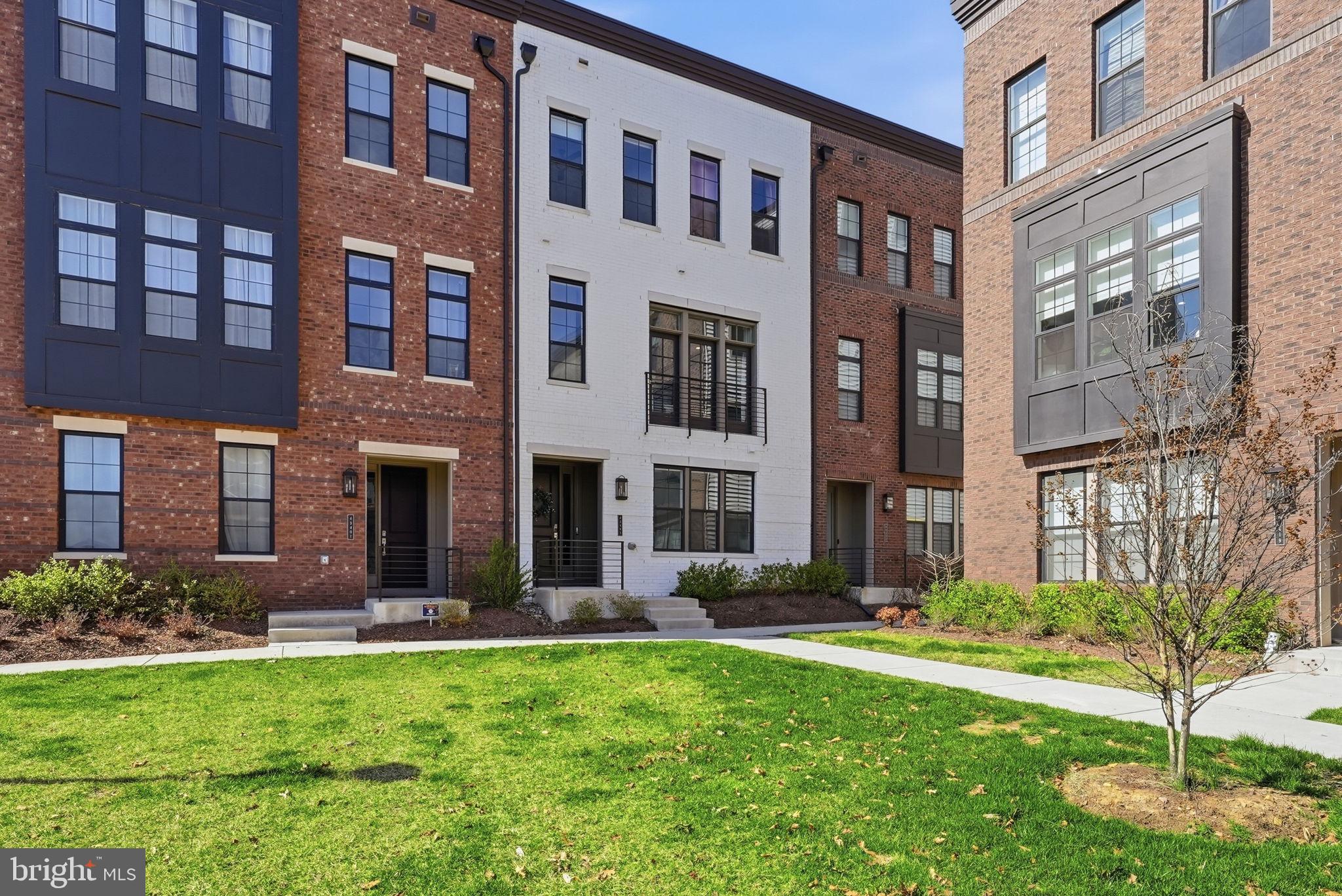 Welcome to 43403 Fifeville Square in Ashburn, a sophisticated four-bedroom, five-bath contemporary townhome built in 2022, offering over 3,000 square feet of thoughtfully curated living space in the highly sought-after Metro Walk at Moorefield Station community.From the moment you enter, the home reveals a quiet elegance defined by natural light, soaring 10-foot ceilings, clean architectural lines, and a seamless sense of flow from one space to the next. The main living level unfolds beautifully with expansive living and dining areas designed for effortless entertaining and comfortable everyday living. Luxury vinyl plank flooring and refined finishes create a warm, modern backdrop that feels both elevated and inviting.At the heart of the home, the designer kitchen balances form and function with striking style. A dramatic oversized island anchors the space, complemented by contemporary granite countertops with a matching granite backsplash, upgraded cabinetry, and Energy Star Whirlpool appliances, including oven, microwave, dishwasher, and 36” cooktop with chimney hood. Just beyond, a private balcony offers a peaceful place to begin the day with coffee or unwind in the evening air.The home’s four spacious bedrooms and three full and two half baths are thoughtfully positioned across the levels to offer both privacy and flexibility. The primary suite serves as a serene retreat with a generous walk-in closet and a beautifully finished bath featuring dual vanities, water-conserving Kohler fixtures, cultured marble surfaces, and a glass-enclosed shower with floor-to-ceiling tile. Secondary baths continue the home’s cohesive aesthetic with timeless finishes and clean design.One of the home’s most captivating spaces is the upper-level loft and rooftop terrace—an exceptional setting for entertaining under the open sky or enjoying quiet outdoor moments. The loft includes a wet bar with a 24” KitchenAid beverage center and opens seamlessly to the expansive terrace, creating a true indoor-outdoor experience.Additional highlights include modern lighting throughout, upper-level laundry, programmable thermostats, Bluetooth-enabled front entry lock, Wi-Fi-enabled garage door, generous storage, and a spacious two-car garage.Set within Metro Walk at Moorefield Station, residents enjoy an exceptional lifestyle with access to a clubhouse, community pool, state-of-the-art fitness center, parks, scenic walking paths, and multiple playgrounds—all just moments from the Ashburn Metro Station, major commuter routes, shopping, dining, and Dulles International Airport.Refined yet welcoming, modern yet timeless—43403 Fifeville Square offers a living experience that feels as good as it looks.Schedule your private showing and experience it for yourself.