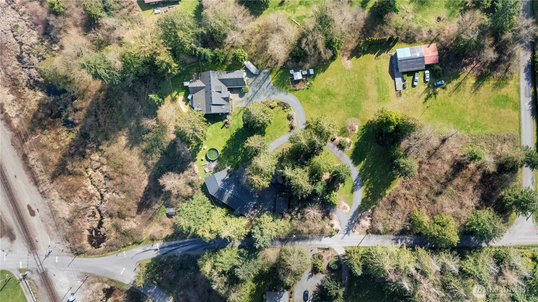 This rare 4+ acre estate features two beautiful, homes, each capturing sweeping mountain and territorial views and offering exceptional flexibility for multi-generational living, rental income, or long-term investment. The 3,000 sq ft main home showcases an open layout centered around an impressive chef’s kitchen with granite countertops and abundant workspace. The main level includes two primary suites, each with a private ¾ bath, oversized walk-in shower, and generous walk-in closet. Upstairs, a bonus room provides ideal space for hobbies, tv, or guests. Outdoor living is equally inviting with a covered porch overlooking the views, a fenced yard, chicken coop, playset, and an automatic backup generator. The second home, a beautifully updated 1,854 sq ft rambler (3 bed/1.75 bath), underwent a renovation in 2018 incl. electrical, plumbing & roof. Expansive windows bring natural light. The kitchen features a walk-in pantry and an eating bar. The primary suite includes an attached sunroom and a spacious bath. Additional features include an attached 1-car garage, storage shed, and a dedicated “retreat cave.” Both homes enjoy stunning views of the mountains, Stillaguamish River, & Portage Creek. The acreage offers a park-like setting with ample parking, including an additional detached garage. Just 1.5 miles from I-5 and 8 minutes to Costco and major amenities. A truly unique property with endless possibilities.