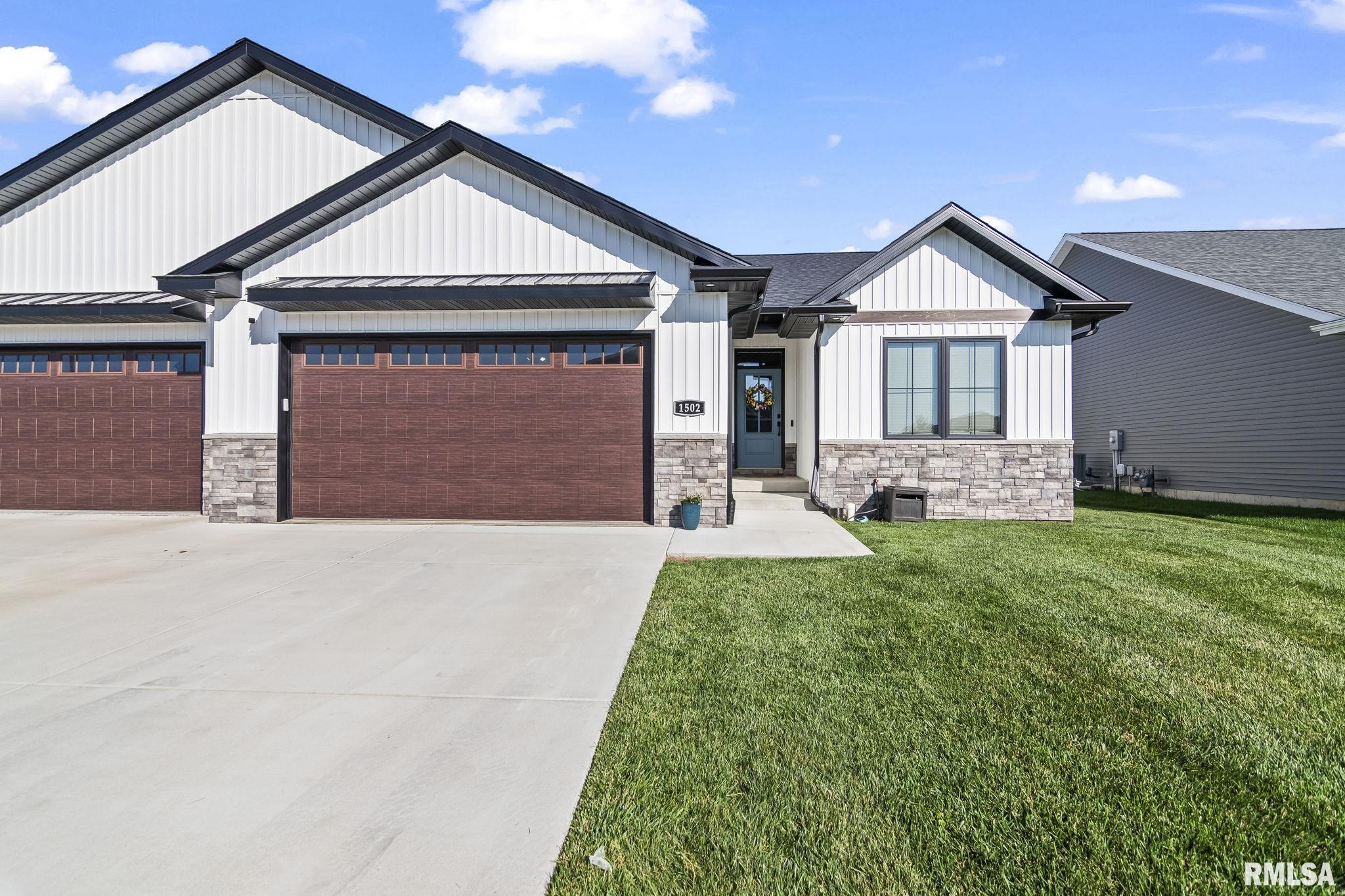 Better than new! This custom-built 2-year-old luxury ranch-style attached home offers approximately 3,500 sq. ft. of thoughtfully designed living space in one of Springfield’s most desirable west-side neighborhoods. Enjoy the benefits of newer construction without the wait, combining luxury finishes with low-maintenance living. Ideally situated on two quiet cul-de-sacs with minimal traffic, it’s perfect for families with children while also offering direct access to the neighborhood walking trail. The open floor plan features beautiful views of the private tree-lined backyard through a triple-door slider leading to a 19’ x 13’ covered patio. The custom kitchen includes Prairie Pride cabinetry, oversized island, farmhouse sink, pot filler, tiled backsplash, floating shelves, and oversized wood hood. The living room features 10’ ceilings, custom beams, built-in cabinetry with lighting, and a floor-to-ceiling stone fireplace. The luxurious primary suite offers a spa-inspired bath, freestanding soaking tub, oversized tile shower, and walk-in closet connected to the laundry room. The finished basement includes two bedrooms, office, full bath, and spacious family room. Oversized 30’ x 22’ insulated 2-car garage, professional interior design selections, and premium finishes throughout. Lives like a single-family home with the convenience of low-maintenance living.