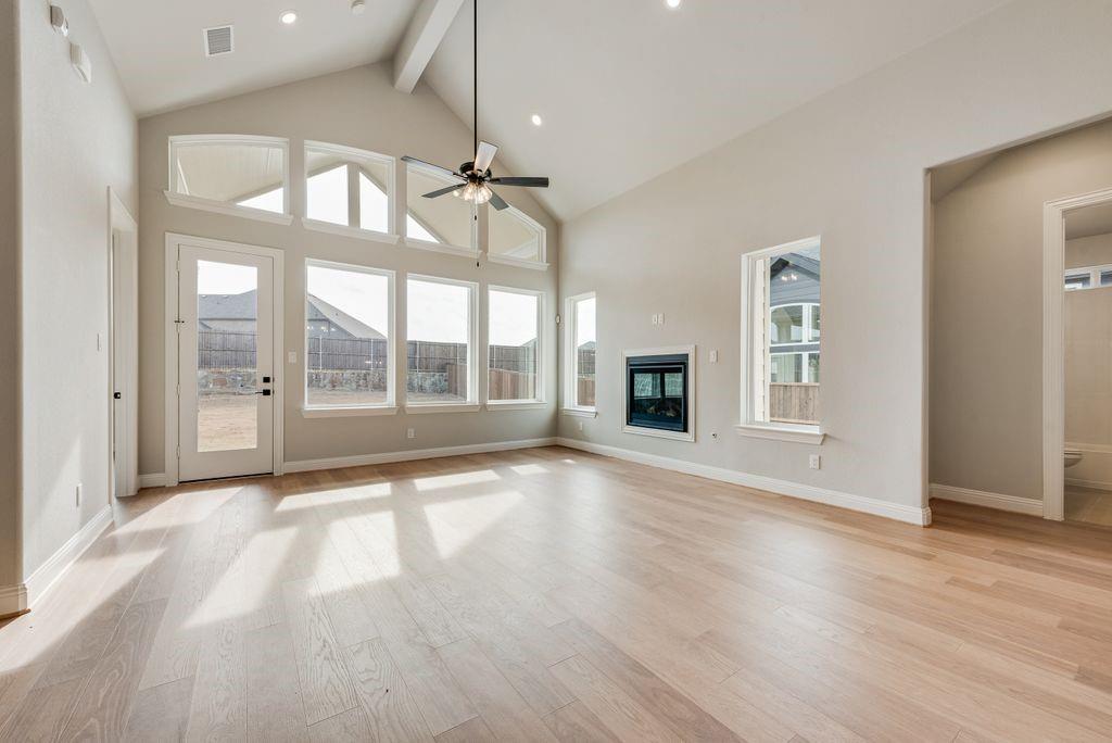 Experience luxurious living in this brand-new Grand Home with a 1 story design and a 3 car garage! Located in Monterra, a premier master-planned community offering exceptional amenities, including a swimming pool, splash pad, scenic bike trails, a park, and pickleball courts. Nestled within the highly acclaimed Rockwall ISD, this beautiful north-facing one-story home features four spacious bedrooms and a three-car garage, all just a short walk from the neighborhood park and pool.The open-concept family room showcases wood floors and a cozy fireplace, seamlessly connecting to a large covered back patio—perfect for entertaining or relaxing outdoors. The gourmet kitchen is a chef’s dream, complete with a generous island, Omegastone slab countertops, elegant white Shaker cabinets, deep full-bowl sink, stainless steel appliances, a five-burner gas cooktop, pots and pans drawers, a large walk-in pantry, and a built-in trash drawer.A flexible layout provides space for a formal living room or home office, while the downstairs media room can easily serve as a kids’ game room or additional entertainment area. Custom finishes include 8-foot doors, pre-wiring for flat-screen TV, and beautiful wood flooring. The primary suite offers a luxurious retreat with a freestanding soaking tub, glass-enclosed shower, dual sinks, and an expansive walk-in closet.Energy efficiency is built into every detail with Energy Star certification, R38 insulation, and a tankless water heater. Enjoy the perfect blend of comfort, style, and convenience—just minutes from Lake Ray Hubbard, with abundant shopping and dining nearby.