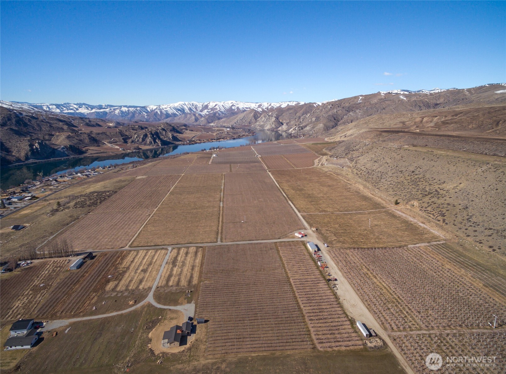 This 250-acre piece of pristine farmland is nestled between Lake Chelan and the Columbia River, offering stunning river and mountain views in a peaceful country setting, yet just minutes from Chelan. Sale includes 15 separate tax parcels. Currently planted with a variety of fruit trees, including apples, cherries, grapes, pears, and a small area of alfalfa. Irrigation water rights available. Continue farming the land or take advantage of this rare opportunity to build your dream estate. There's even space for small runway if desired. Whether you're looking to create a world-class equestrian facility, destination event venue, large private estate, or something else entirely, this location is perfect for bringing your vision to life.