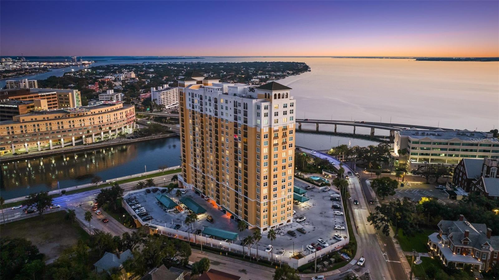 Penthouse-level luxury high-rise living on iconic Bayshore Boulevard with sweeping water and skyline vistas from every room. This penthouse-level residence offers 2 bedrooms, 2 baths, and two deeded parking spaces, plus a rare air-conditioned storage room. A smart split-bedroom layout centers on an open living/dining area and a bright, well-appointed kitchen with white cabinetry, granite counters and backsplash, breakfast bar, and tile flooring. Triple sliding glass doors extend the living space onto a private balcony for sunrise coffee and evening lights.The primary suite features a custom walk-in closet and a beautifully renovated spa-inspired bath with built-ins, a walk-in shower, and soaking tub. The secondary bath has also been recently renovated with stylish finishes, while the secondary bedroom is ideal for guests, a home office, or den. Fresh paint, neutral finishes, crown molding, hardwood floors in the main living areas, and a newer HVAC system make this home truly move-in ready.Building amenities include 24/7 concierge, two fitness rooms, pool, outdoor grill area, separate men’s and women’s saunas, conference room, wine cellar, EV charging, pet walk, bike storage, and car wash, plus two furnished guest suites for visitors. Exceptional walkability to the Tampa Riverwalk, Hyde Park Village, Amalie Arena, museums, parks, grocery stores, dining, and healthcare, with quick access to downtown, Davis Islands, major highways, and Tampa’s airports. Pet-friendly community. Come enjoy Bayshore living—schedule your private showing today.