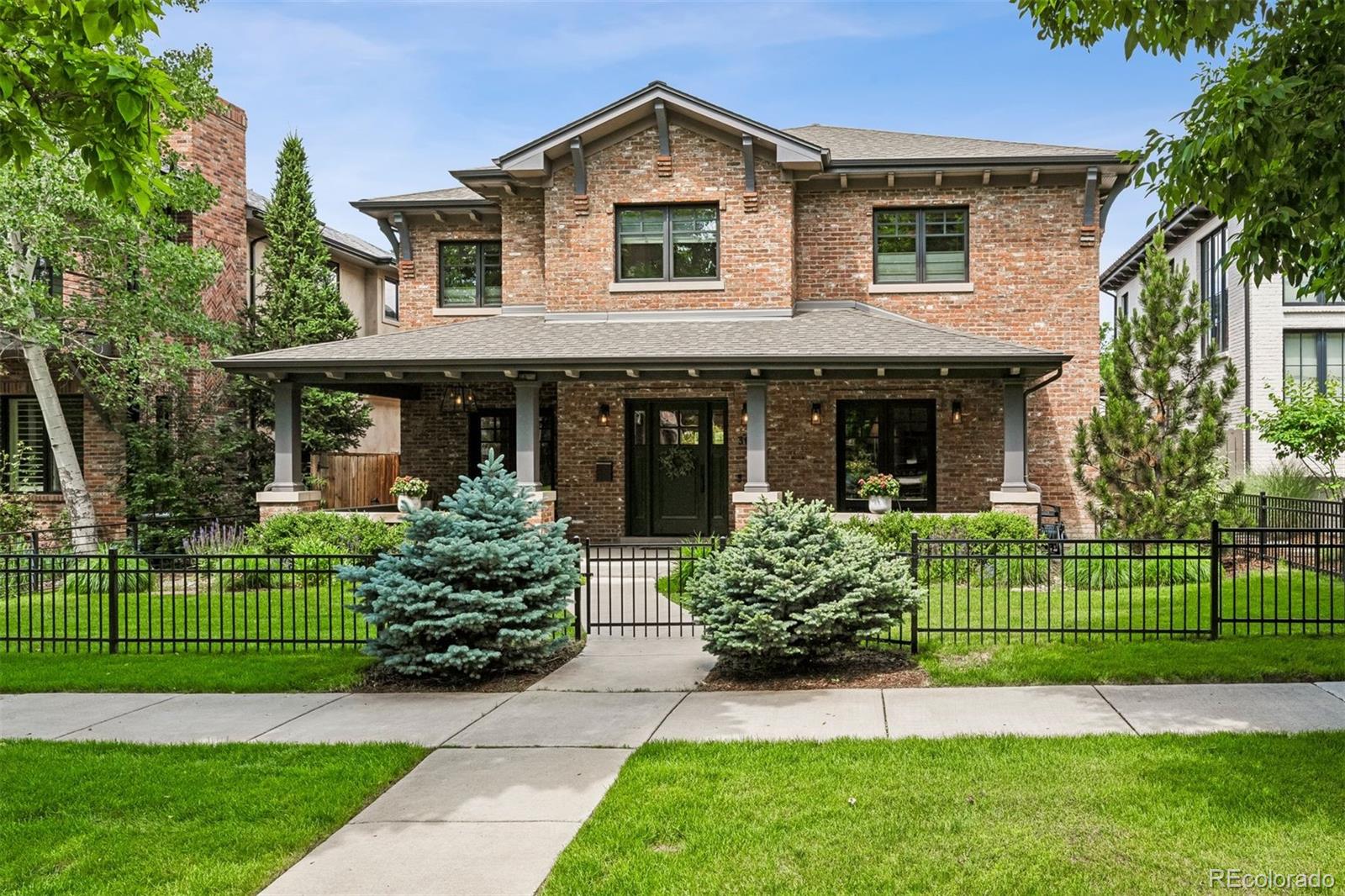 Rare opportunity in Wash Park! This all-brick traditional, thoughtfully designed by Gunlock Homes and offered by its original owners, combines timeless architecture with an ideal location. The main level features a smart floorplan with formal dining, a butler’s pantry, private office, and an open kitchen with a large center island that flows into the living room. Here, a fireplace with custom wainscot surround is the centerpiece, framed by elegant box-beam ceilings overhead. French doors open to a pergola-covered patio, landscaped yard, and a built-in outdoor kitchen—perfect for entertaining. Upstairs, all four bedrooms include ensuite baths, highlighted by a spacious primary suite with five-piece bath and walk-in closet, plus a full laundry room. The finished basement adds a large rec room and two additional bedrooms (one currently used as a gym).  Set on a 6,240 sq ft lot with a detached two-car garage, this home blends character, comfort, and convenience just minutes from Wash Park, Cherry Creek, top schools, and Denver’s best shopping and dining.
