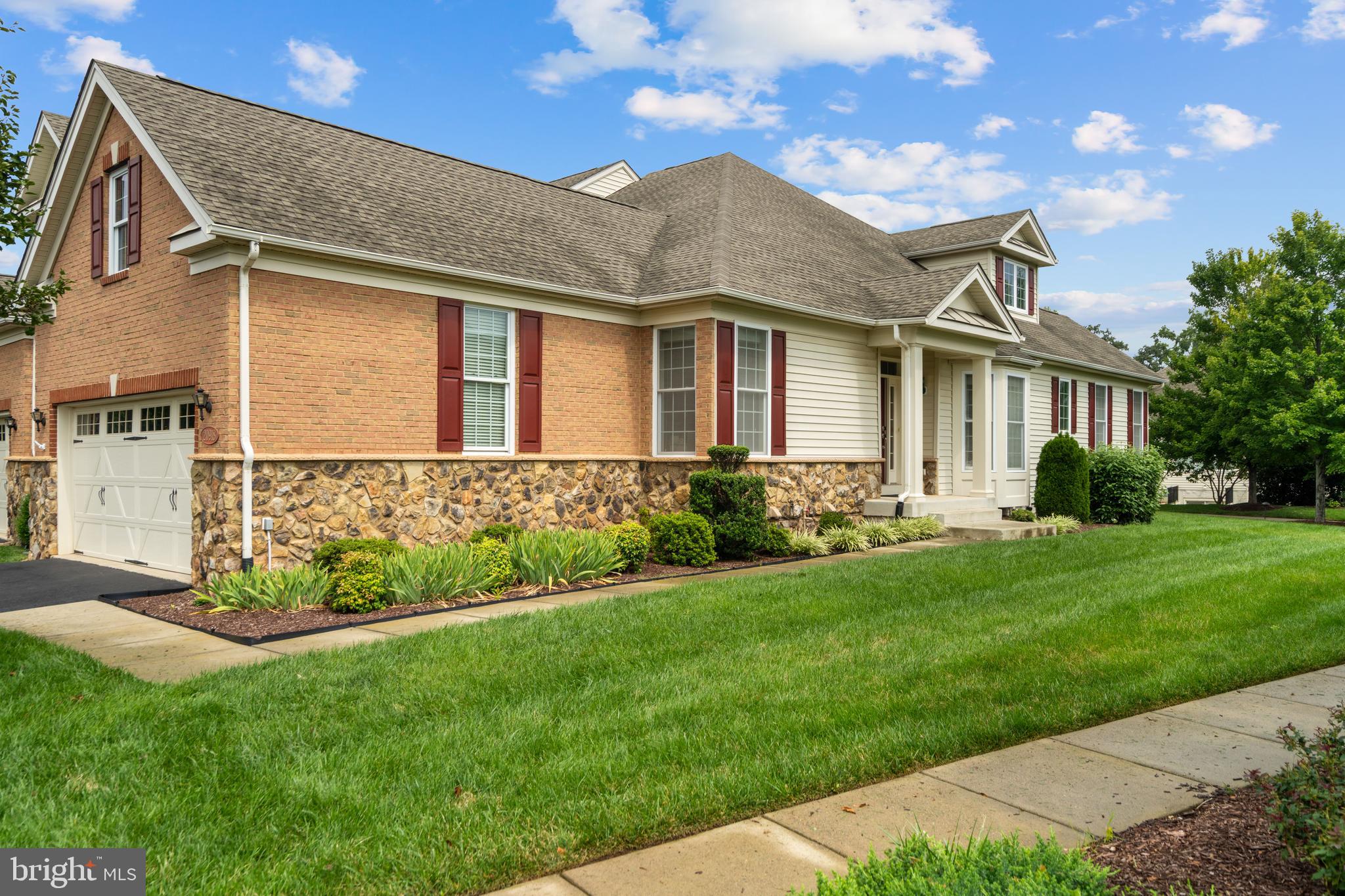 Embrace effortless, amenity-filled living in the highly sought-after Regency at Ashburn, a premier 55+ active adult community designed for enjoying life to the fullest! This beautifully maintained end-unit carriage home seamlessly combines main-level convenience, versatile living space including a loft, and unbeatable neighborhood amenities. Arrive to manicured lawns, mature trees, and a tranquil atmosphere that instantly feels like home. Inside, an open, sun-filled floor plan, pristine hardwood floors, modern lighting, and an open-concept kitchen. The kitchen showcases granite countertops, premium appliances, and plenty of cabinet storage and a pantry. Step through the adjacent dining/living area onto your covered porch to relax outdoors with serene views. Designed with easy living in mind, the main floor also features a spacious living room, dining room, and two light-filled bedrooms. The primary suite offers a large bedroom with a tray ceiling, walk-in closet, and a spa-like ensuite bath complete with a double vanity and walk-in shower with a built-in bench. The second bedroom is located right next to the second full bathroom, offering optimal privacy for visiting guests. What makes this home extra special is the loft, including a very large bedroom and an additional full bathroom, perfect for when the family comes to visit. Grandkids love a loft! A convenient main-level laundry room with a utility sink makes daily chores effortless. Downstairs, the unfinished space features a walk-up basement, perfect for storage or transformation to your liking. Outside your door, enjoy true maintenance-free living with all lawn care provided. This home also gives new meaning to “Fit and 55+” through its amazing facilities. Take advantage of a gated setting with walking trails, a community center, outdoor pool, fitness facilities, a bocce court, and endless social clubs, plus close proximity to the Ashburn Senior Center, and One Loudoun dining and shopping. In addition, residents have access to the Ashburn Village Sports Pavilion, featuring premier amenities such as year-round aquatic facilities, a state-of-the-art fitness center, tennis and pickleball courts, and much more! Welcome to your next vibrant chapter! Schedule a showing today!