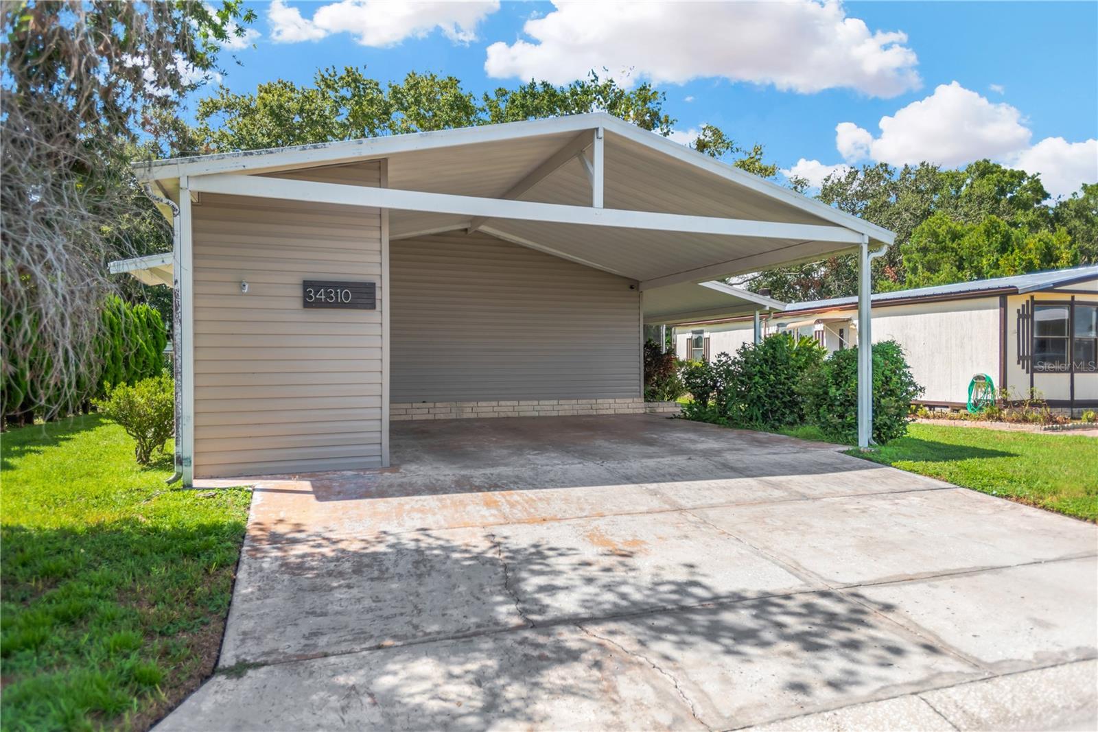 Welcome to your new home in the GATED COMMUNITY of Timber Lake Estates.  This nicely updated home features 3 bedrooms and 2 bathrooms.  There is lot rent in this community and you have a low HOA payment of only $196/month that covers water, sewer, trash collection with access to two pools and two clubhouses.  The home has an open concept kitchen/dining/living room combo that is bright and spacious with lots of cabinet space. There is also new flooring throughout the house. The laundry room is conveniently located off the kitchen.  You will have a screened lanai which is perfect for sitting and enjoying your morning coffee or barbecuing some burgers and hot dots while entertaining guests.  No age restriction in this community and pets are OK with some breed and weight restrictions. Come see this home before it's gone!