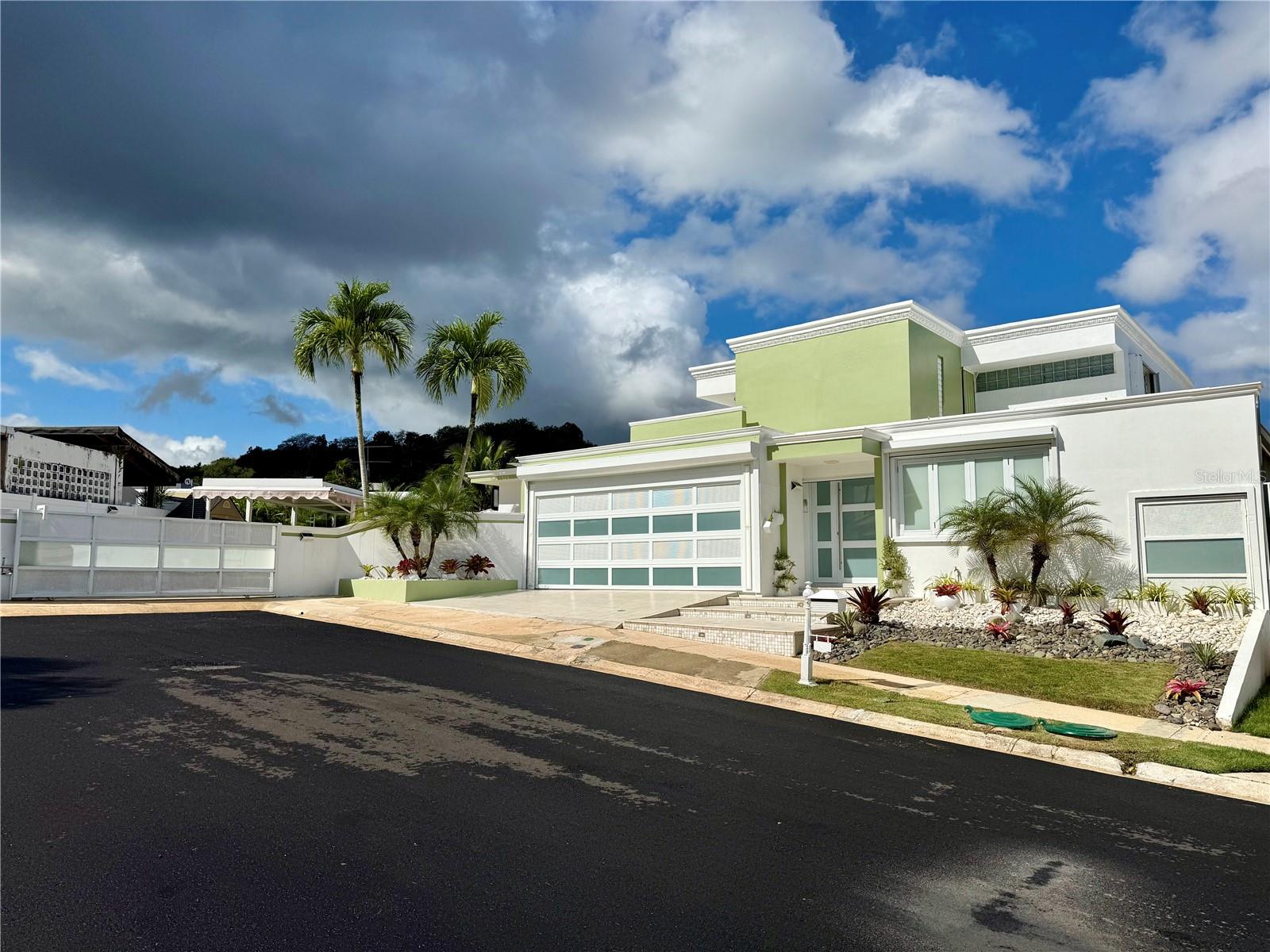 Luxury Residence for Sale in GuaynaboDiscover an exceptional opportunity to own a beautifully remodeled residence in the gated community of Mansiones Reales, Guaynabo. Designed with comfort, versatility, and entertaining in mind, this impressive property offers generous interior and exterior spaces complemented by outstanding private and community amenities.The residence features 5 spacious bedrooms, 3.5 bathrooms, two living rooms, two dining areas, two kitchens, a family room, and a dedicated laundry area. Its thoughtfully designed layout provides flexibility for everyday living, entertaining, working from home, or accommodating guests.The outdoor areas are equally impressive, featuring a covered terrace with pool table, private swimming pool, basketball area, gym, and gazebo, creating an exceptional environment for relaxation and entertainment.Additional features include a two-car garage and a full-capacity automatic generator, providing added convenience and peace of mind.Residents of Mansiones Reales also enjoy access to community amenities including tennis, basketball and volleyball courts, recreational areas, and clubhouse facilities.Completely remodeled and ready for its next owner, this distinctive residence presents a rare opportunity to acquire a spacious and well-appointed home in one of Guaynabo’s established residential communities.