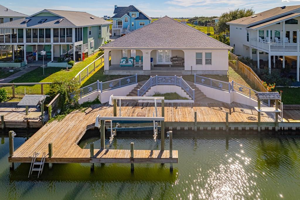 Enjoy the coastal life of fishing & hunting in this one-story waterfront home. In the coveted Bahia Bay community. This 4 bedroom, 3 bath home with an additional Bunk Room offers space for the entire family. It features a HUGE game room with bar & large TV. The Primary suite is large and a full walk-in closet and spa bathroom with jetted tub tops it off. Walk out to the covered patio overlooking the boat dock and fish cleaning station. Features a 3 car garage. Enjoy the canal views and short boat ride to great fishing! Sold furnished. DON'T MISS OUT ON THIS BEAUTY!