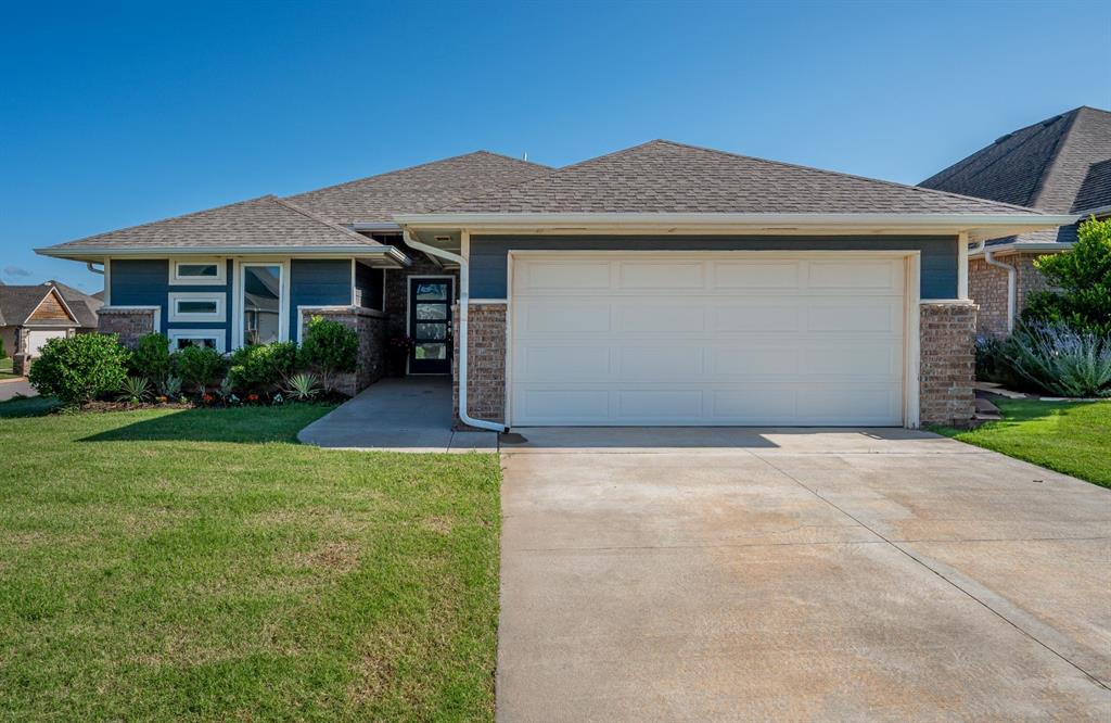 This beautifully designed home features wood-look tile flooring throughout the main living areas, including the living room, kitchen, dining, and hallways; fireplace, tankless hot water heater, and an in-ground storm shelter located in the garage. The kitchen is a standout with shaker-style cabinetry that goes up to the ceiling, 3CM quartz countertops, under-cabinet lighting, chevron tile backsplash, a pantry, and a large island with a stainless steel apron sink. In the spacious primary suite you will find a vaulted ceiling and an ensuite bathroom with tile flooring, dual-sink vanity, tiled walk-in shower, jetted tub, water closet, and direct access to the walk-in closet which leads directly to the laundry room. Out back, enjoy a covered patio with a built-in outdoor fireplace, gas hookup, and a fully privacy-fenced yard. Neighborhood amenities include a playground and basketball court. Short commute to John Kilpatrick Tpke access, Mercy Hospital, several country clubs, dining options and more. This one checks all the boxes—come see it before it's gone!