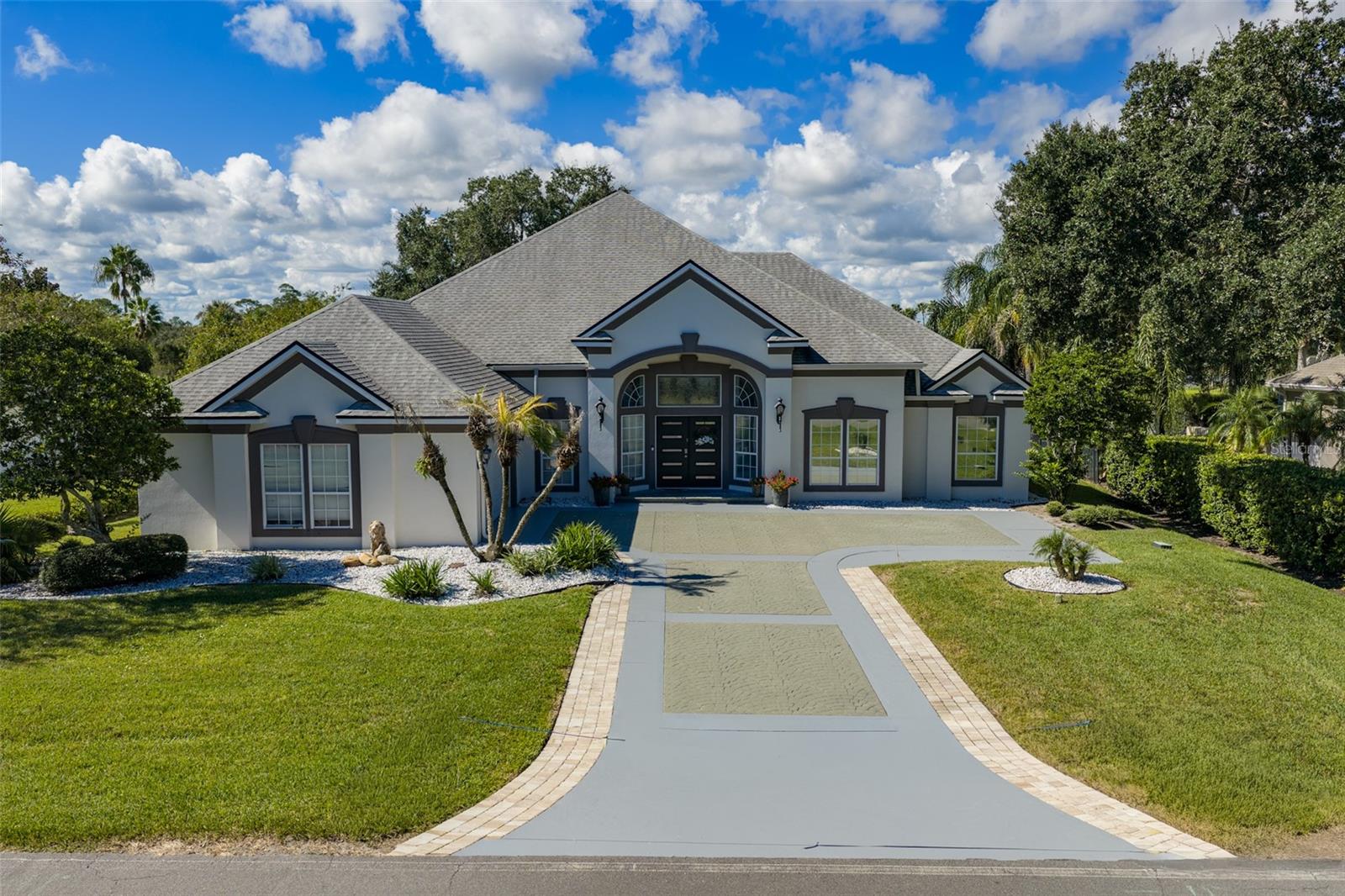 Luxury Living with Breathtaking Golf Course & Lake Views in Marsh Creek Country Club! Welcome to this absolutely stunning, completely remodeled 4-bedroom, 3.5-bathroom home nestled in the highly desirable Marsh Creek Country Club community! Offering breathtaking views of the golf course, lake, and marsh, this one-of-a-kind property perfectly blends luxury, comfort, and Florida living at its finest. From the moment you step inside, you'll be captivated by the beautiful finishes, tile flooring throughout, and bright, spacious open-concept layout. The gorgeous, completely remodeled kitchen is truly the heart of the home, featuring an expansive design that flows seamlessly into the oversized living room. Soaring windows flood the space with natural light while showcasing beautiful views of the screened-in pool and surrounding landscape. Perfect for entertaining, the home also features a fabulous wet bar complete with an ice machine, wine refrigerator, and sink! Step outside to your very own private paradise! The expansive screened-in patio features a fantastic outdoor bar and seating area, along with a beautiful heated pool overlooking the peaceful lake and lush golf course. Whether you're entertaining guests, enjoying your morning coffee, or unwinding after a long day, this outdoor space is nothing short of spectacular! The spacious primary suite offers a luxurious retreat, complete with two oversized walk-in closets and a beautifully remodeled ensuite bathroom featuring an enormous walk-in shower and a separate spa tub designed for ultimate relaxation. On the opposite side of the home, you'll find two generously sized guest bedrooms and a beautifully appointed full bathroom, providing plenty of comfort and privacy. Upstairs, discover an incredible oversized fourth bedroom with its own private ensuite bathroom and balcony showcasing breathtaking panoramic views of the golf course, marsh, and lake! This versatile space offers endless possibilities as a private guest suite, additional living area, entertainment room, or luxurious home office. Located in the prestigious Marsh Creek Country Club community, residents can enjoy a beautiful golf course, clubhouse,