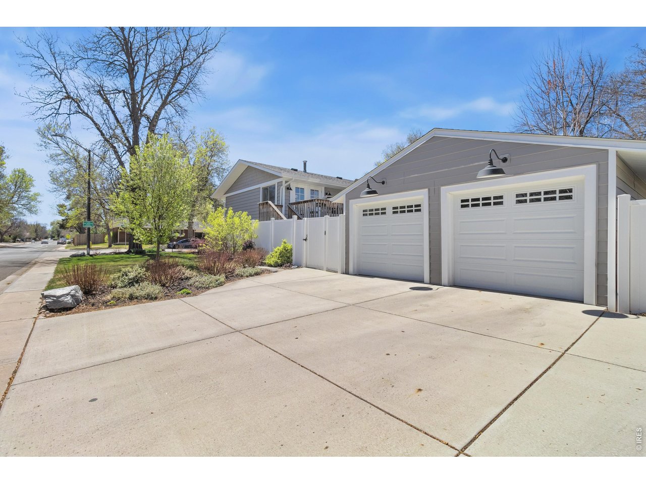 Immaculate midtown Fort Collins home on a .19-acre corner lot, originally built in 1964 and beautifully updated throughout. Located in one of Fort Collins' most highly desirable areas, this home offers the perfect blend of charm, convenience, and modern upgrades. The south-facing layout fills the home with natural light, and the upgraded kitchen is a true highlight-featuring quality finishes, excellent flow, and a layout that's ideal for both everyday living and entertaining. Upstairs, you'll find an open-concept living and dining area with solid hardwood floors, along with two comfortable bedrooms and a full bath. Just off the dining room, step onto the Trex deck-perfect for relaxing or hosting, with easy access to the backyard. The lower level includes two additional bedrooms, a 3/4 bath, a spacious laundry room, and a versatile non-conforming 5th bedroom-currently used as a primary suite, with the only non-conforming aspect being the absence of a closet. It also works well as a second living area depending on your needs. Outside, the detached two-car garage and oversized concrete driveway provide ample parking and flexibility for multiple vehicles or guests. The landscaping is well maintained and adds to the home's overall appeal. Recent upgrades include a new sprinkler system, garage doors, electrical panel, luxury siding, and enhanced attic insulation and sealing-offering added comfort and peace of mind.All of this with close proximity to Old Town, CSU, parks, trails and shopping making it easy to enjoy everything Fort Collins has to offer.