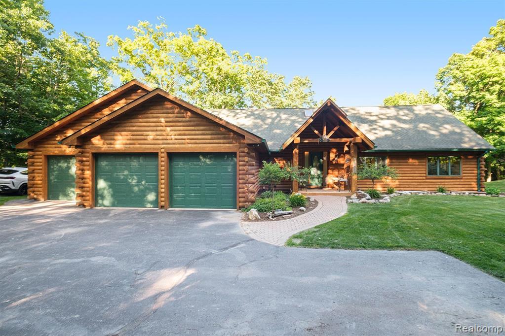 Imagine owning this extraordinary luxury log cabin home, nestled in a breathtaking setting with the soothing sounds of a waterfall, unfolding as a serene oasis. With its expansive property spanning almost six acres, complete with a large pond, this haven offers a tranquil and private environment for nature enthusiasts to unwind and recharge. As you enter this magnificent home, you are greeted by a two-story great room with an abundance of windows, offering awe-inspiring views that evoke a deep sense of relaxation, serenity, and tranquility. A grand staircase contributes to the airy and open feel of the home, leading to the upper level, where dreams, aspirations, and limitless possibilities come alive. The main kitchen is a gourmet chef's dream, boasting ample counter space and elegant cabinetry, making it perfect for meal preparation, hosting guests with flair and finesse, and creating unforgettable culinary experiences. This luxurious log cabin features 3 spacious beds 2 on lower level,  each designed with comfort, style, and inspiration in mind. The primary bedroom is a true retreat, featuring a lavish en-suite bathroom. The finished lower level of this home is an entertainer's paradise, complete with a second kitchen, ideal for hosting gatherings, accommodating guests with ease and warmth, and creating lasting memories. Walkout access leads to a beautifully landscaped backyard, offering picturesque views of the water, inviting outdoor exploration, adventure, and a profound connection with nature. A MUST SEE!