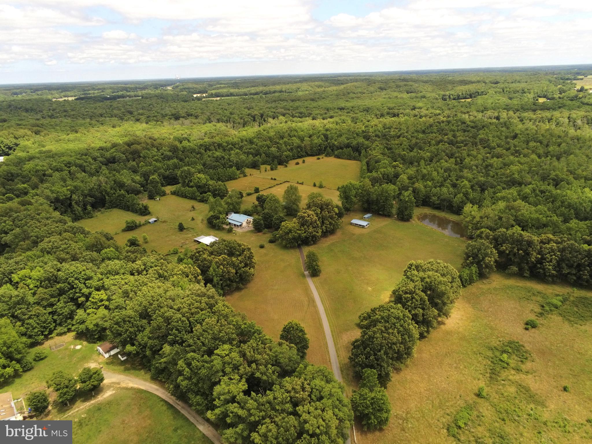 94-Acre Equestrian Estate & Event Venue Opportunity – Offered at $4,500,000 Welcome to an extraordinary 94-acre private estate in Charles County, Maryland, where luxury, recreation, equestrian living, and income-producing potential come together. This remarkable property has received Charles County zoning approval for events, making it an exceptional opportunity for a private retreat, horse farm, event venue, agritourism operation, or family compound. The property features approximately 30 acres of fenced pastureland divided into eight separate paddocks, ideal for horses, livestock, or agricultural use. A picturesque one-acre stocked pond offers excellent fishing with bass, bluegill, trout, and catfish. The acreage is further enhanced by valuable timber resources including gum, oak, pine, walnut, maple, and pulpwood. At the heart of the estate sits a spacious 4,270-square-foot residence offering 5 bedrooms, 3 full bathrooms, and 2 full kitchens, making it perfect for multi-generational living, guest accommodations, or event operations. Additional features include a durable metal roof and a large, screened porch overlooking the peaceful surroundings. Supporting the property are five outbuildings, each equipped with a minimum of 300-amp electrical service, providing outstanding flexibility for equestrian, agricultural, workshop, storage, or event-related uses. Privacy is unmatched, with a stunning 2,500-foot private driveway leading to this secluded retreat. A planned 20-foot access road further enhances accessibility and future development potential. Despite its private setting, the property is conveniently located just minutes from downtown La Plata and approximately 30 miles from Washington, D.C., offering easy access to urban amenities while maintaining a true countryside atmosphere. Offered at $4,500,000 Private showings by appointment only. Contact the listing agent for additional information and to schedule your private tour. Property Address: 5745 Cues Favorite Place, Waldorf, MD 20602