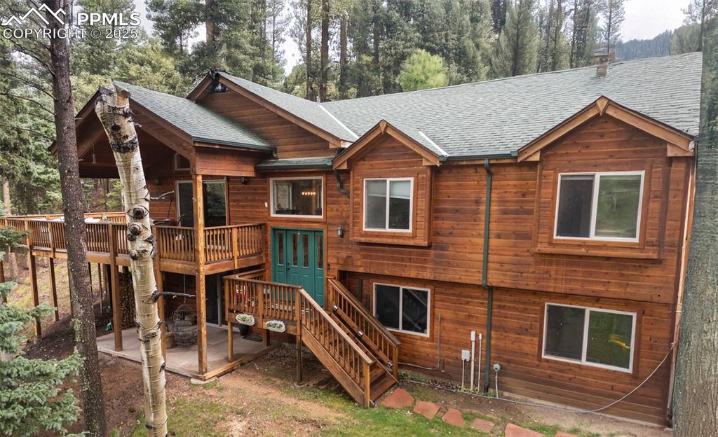 Escape to your private mountain retreat in Woodland Park, just minutes from Catamount Reservoir. Tucked on a secluded 1.5-acre treed lot, this 4-bedroom, 3-bath home blends alpine charm with thoughtful updates. The main level offers three bedrooms, including one with an en-suite bath, while the lower level boasts a spacious suite with fireplace, private patio area and a walk-in closet. Relax outdoors on the huge deck and enjoy the crisp Colorado evenings in the cozy hot tub. With an oversized 2-car garage plus a detached shop or studio, you’ll enjoy total privacy with the convenience of being only 15 minutes from shopping and dining in town.