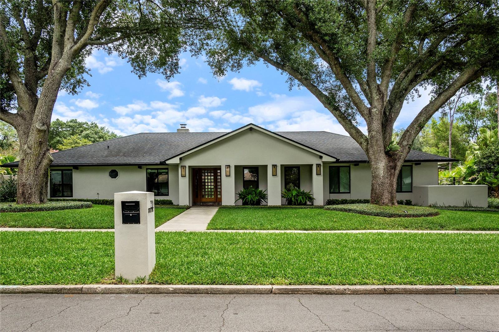 Welcome to 220 Adams Drive — a breathtaking, completely remodeled single-story masterpiece nestled in the heart of Maitland's coveted Kings Row neighborhood. Thoughtfully reimagined from the studs out with exquisite craftsmanship and elevated design, this stunning home offers 4 bedrooms, a dedicated private office, 3.5 baths, and over 3,000 square feet of refined living on a fully fenced, oversized lot.The renovation is truly comprehensive — all-new plumbing, electrical, ductwork, and three separate AC units provide complete peace of mind. Spray foam insulation delivers exceptional energy efficiency, propane gas powers the chef's kitchen cooktop and tankless hot water heater, and Lutron touch-slide dimmers indoors plus automated Lutron outdoor lighting give the home a level of sophistication and control that is rarely found at any price. French drains round out a property that has been engineered as thoughtfully as it has been finished.Step through a charming covered front porch and into a bright, open-concept interior where elevated ceilings, rich wood floors, and designer recessed lighting create an effortlessly elegant atmosphere. The chef's kitchen is a showstopper — outfitted with high-end appliances including a gas cooktop, custom white cabinetry, clever appliance garages, and bespoke built-ins that marry beauty with function. The warm and inviting living room anchors the home with a wood-burning fireplace and seamless sliding doors to the pool beyond.The split-bedroom layout offers exceptional privacy for every member of the household. The oversized primary suite features a spa-inspired en suite with a double-sink vanity, walk-in glass shower, and soaking tub — plus a large walk-in closet with custom built-ins. The second bedroom enjoys its own private en suite with a walk-in shower, perfect for guests or multi-generational living. Bedrooms three and four share a well-appointed hall bath with a tub/shower combination.Outside, your private resort awaits. The saltwater pool with sunshelf is the perfect centerpiece, framed by a covered cabana with fireplace and a fully equipped outdoor kitchen. The Lutron automated lighting system extends seamlessly to the exterior, creating effortless ambiance day and night. The fully fenced yard offers privacy and room to breathe.The property features a two-car garage and a separate one-car garage — both finished with epoxy floors. The one-car garage is currently appointed as a private home gym with an adjacent storage room, offering flexible utility from day one.Located in a quiet, tucked-away neighborhood with a community park and playground, this home is just minutes from Winter Park, Park Avenue, the Winter Park Racquet Club, and scenic parks and trails. Zoned for top-rated Dommerich Elementary, Maitland Middle, and Winter Park High School.Homes of this caliber — fully rebuilt, impeccably finished, with every system new — are extraordinarily rare. Schedule your private showing today.