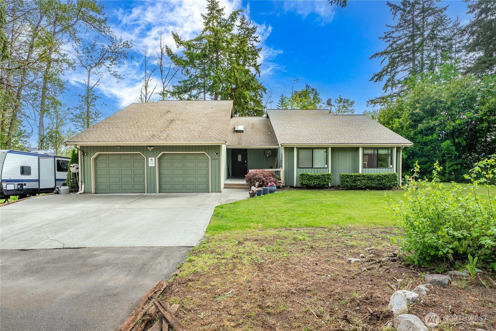 Welcome to your very own woodland retreat in Edgewood, full of natural light! Beautiful, open concept kitchen with walk-in pantry, overlooking a spacious living space that expands onto the home's large upper deck. There's a cozy wood fireplace for those rainy days - and AC for the hottest part of summer! You'll feel like royalty waking up in the expansive primary suite with vaulted ceilings, walk-in closet and its own private entry onto the deck. The en-suite bath has plenty of storage and even a built-in vanity! Two additional bedrooms and laundry on main floor make this home convenient and functional for daily living. Downstairs is an entirely separate living space, complete with its own lovely kitchen and deck - making this home a winner for multi-gen buyers & investors alike. Lower apartment with large bedroom + walk-in closet, addl large bonus room, & heated extra storage room. Just off the back deck, you'll find the heated wood shop/ flex space, perfect for hobbies! Huge two car garage with plenty of additional storage as well! All this on over 2.25 acres on a private, dead-end street.  Nestled in the heart of Edgewood, this property offers the perfect balance of privacy and convenience. Surrounded by mature trees and nature, while remaining just minutes from shopping, dining, parks, & schools - only minutes to 167 or I-5. Nearby golf courses, local coffee shops, and community events add to the charm of this sought-after area. Come take a look, and make it yours today!