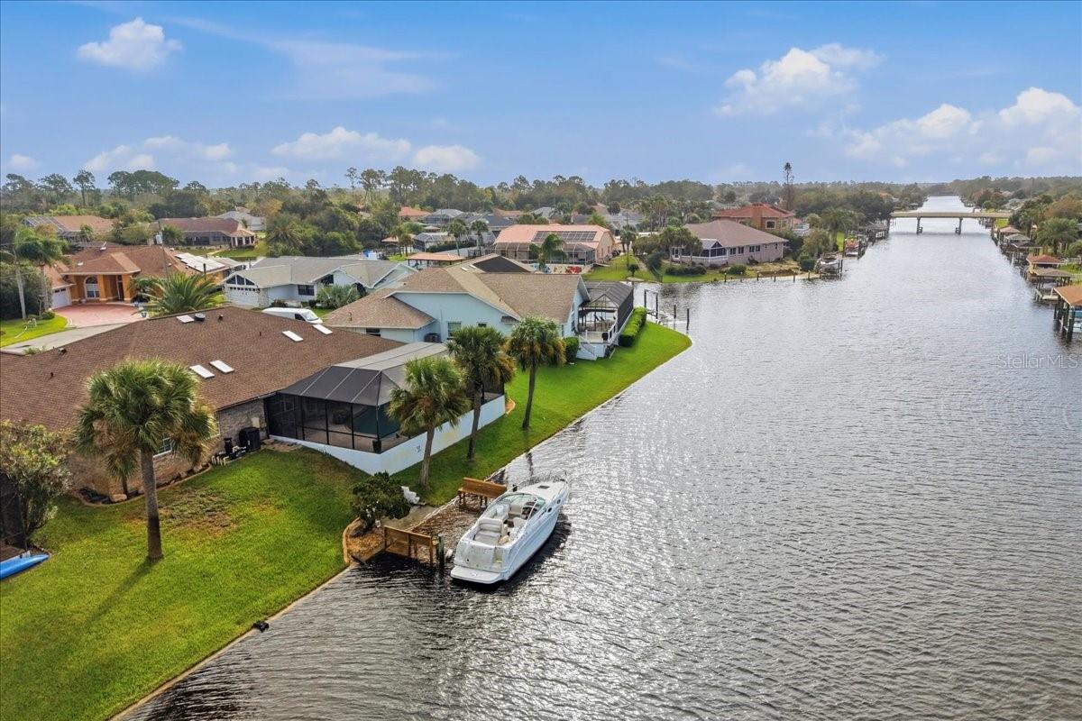 Waterfront Living at Its Finest: Canal Home with Unbelievable Water ViewsPicture your mornings with coffee by the pool, boats gliding past on the main canal. In the evening, the sun sets over the water from your own covered cove. This beautifully kept 3-bedroom, 3-full-bath home sits at the end of a quiet cul-de-sac. Its side-tip location looks out over two intersecting canals, so you get sweeping water views from nearly every room.The curb appeal is clear from the moment you arrive. A circular driveway has room for plenty of cars, and the home has been lovingly cared for and is in spectacular condition. Big-ticket items are done: the roof is from 2024 and the AC from 2025.Inside, the split floor plan is spacious and bright. The front formal room would make an ideal home office or game room. Toward the back, the large family room opens to a huge kitchen with a center island and a great pantry, made for cooking and entertaining. All of it looks out over the water.The primary suite is a true retreat. Sliding glass doors open straight to the pool, and the bath has dual vanities, a large walk-in shower in the center, and two closets. Every bedroom is generously sized with plenty of closet space.Outdoors, the oversized pool is a joy to swim in. A large covered patio, a full pool bath, and a covered cove for sunset evenings make it easy to live outside year-round. Bring your boat to the private dock and enjoy main-canal living. You’ll also find an inside laundry room and a garage with tons of built-in storage.There’s no HOA and no CDD, and Flagler Beach is just about 15 minutes away. Homes like this don’t stay on the market long, and this one is priced to sell. Schedule your showing today!
