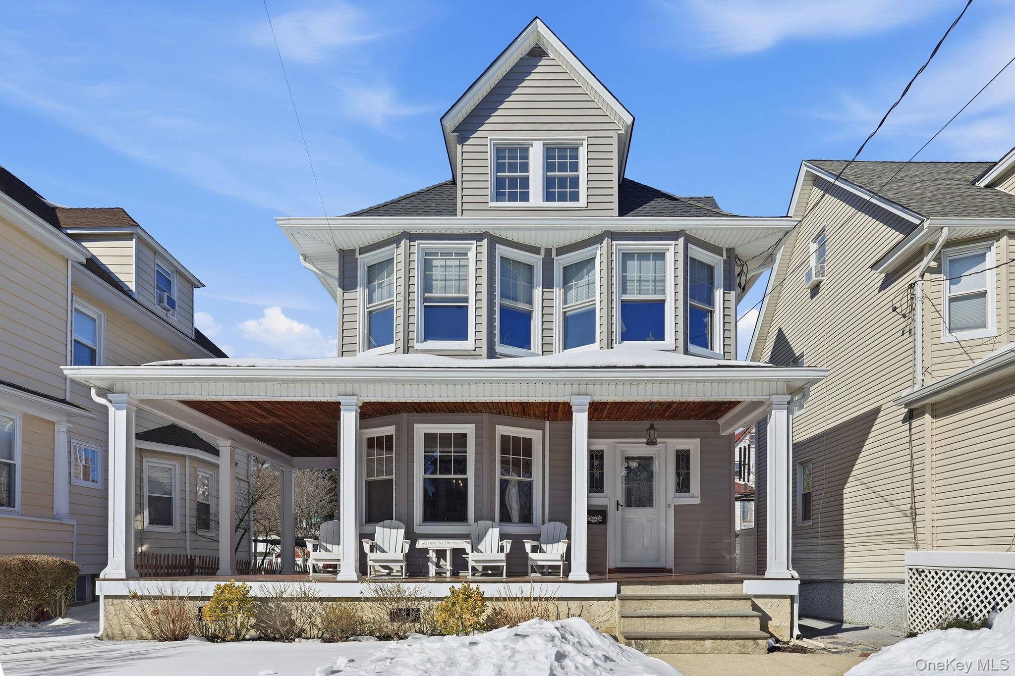 Classic Victorian charm awaits its new owner in this impeccably maintained New Rochelle gem. A welcoming wrap-around front porch sets the tone for this light-filled three-story home, where abundant windows bathe every room in natural sunlight. Enter through a spacious, welcoming foyer that leads to a living room with fireplace, formal dining room, and a nice-sized eat-in kitchen, perfect for everyday living and entertaining.The second floor enjoys a large landing featuring four versatile bedrooms, currently configured with one as a home office and another as a den, plus an updated hall bath. Ascend to the third floor to discover a private bedroom retreat with an extraordinarily large full bath and finished space—ideal for a home office, studio, or guest suite.The lower level offers an additional finished 315 sq. ft., new wainscoting, and a large laundry room with sizable storage space. An expansive back cedar deck overlooks a flat, usable yard and is accessible via kitchen sliders or living room French doors. This home is perfect for seamless indoor & outdoor gatherings. Located close to the vibrant restaurants and shops of downtown New Rochelle and less than a mile to the train for a quick commute to NYC. With low taxes and timeless Victorian character, this New Rochelle beauty is a must-see!