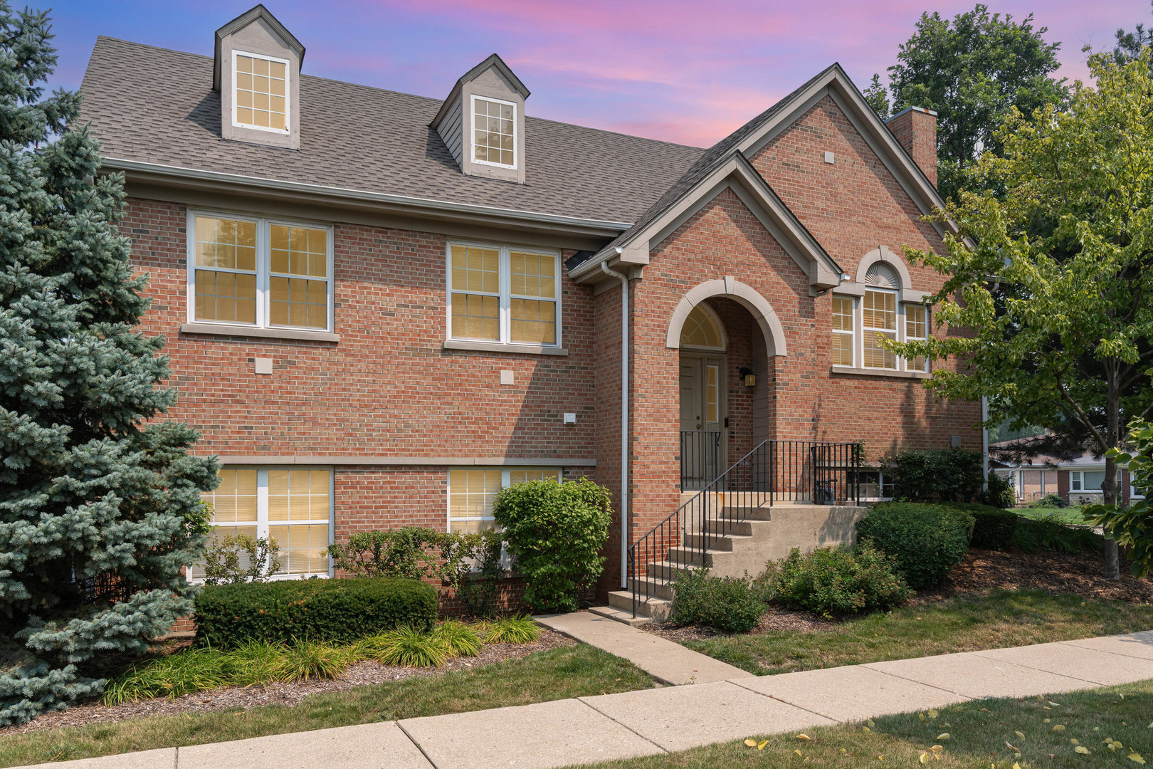 Welcome to this beautifully maintained and upgraded townhome in the desirable Laramie Park community of Skokie, offering the perfect blend of modern comfort and convenient location. This bright and spacious residence features 3 bedrooms and 2 full bathrooms across two thoughtfully designed levels, with soaring 9-foot ceilings that create an open and airy feel.  The main living area is highlighted by a generous open-concept layout, perfect for both everyday living and entertaining. The large family room flows seamlessly into a stylish kitchen and dining area, while custom real wood blinds throughout the home add warmth and elegance. The kitchen is equipped with stainless steel appliances - including a brand-new refrigerator and oven/range (2024) - and opens to a private balcony, ideal for enjoying morning coffee or evening sunsets.  Retreat to the spacious primary suite with a walk-in closet and a well-appointed en-suite bath. The home also features a versatile lower level with a large family room and third bedroom/den, perfect for a home office, guest space, or playroom.  Recent upgrades include fresh paint throughout, new top-of-the-line windows, and a new A/C unit (2024), ensuring both style and energy efficiency. The attached 2.5-car garage and additional visitor parking make day-to-day living even easier.  Located just minutes from downtown Skokie, Oakton Park, the Skokie Swift Yellow Line, top-rated schools, and a variety of shops and restaurants, this home offers the feel of a single-family residence with the convenience of townhome living.  Don't miss the opportunity to make this exceptional Skokie property yours.