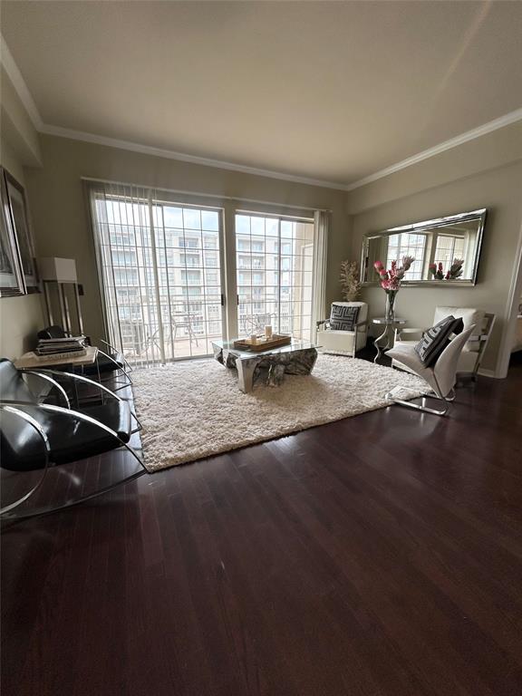 Living room featuring ornamental molding and dark wood finished floors