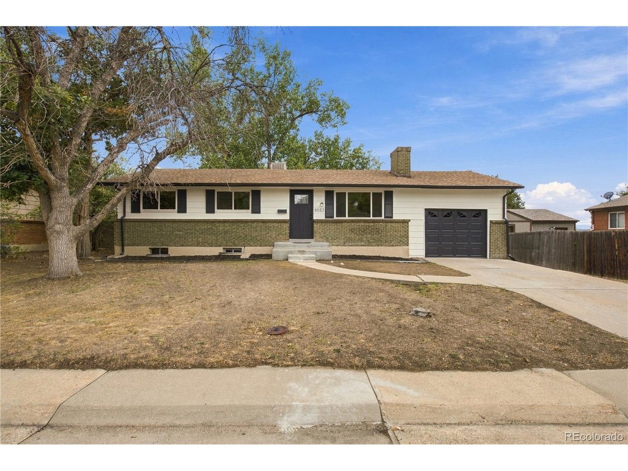 Welcome home to this peaceful Shaw Heights ranch, offering flexible living space, thoughtful updates, and a spacious 7,992 SF lot just minutes from neighborhood parks, shopping, and major routes. The bright main level features a welcoming living room plus dining area with refinished hardwood floors, and sliding door access to the large back deck and pergola, perfect for outdoor entertaining and relaxing. The kitchen lots of storage including a pantry, LVP flooring, and new stainless steel appliances including refrigerator, electric range, over the range microwave, and dishwasher. Direct access to the attached tandem garage adds everyday convenience. Three main level bedrooms share a beautifully updated full bathroom with a convenient hall linen closet. Downstairs, the finished basement provides plenty of room to spread out with a large family room featuring a brick fireplace, spacious fourth bedroom with egress window, home office, custom tiled 3/4 bathroom, and laundry room. Enjoy the partially fenced backyard, oversized deck, and pergola for shaded outdoor living. The location adds to the appeal, with Shaw Heights Middle School and Oakwood Park within walking distance, plus convenient access to nearby shopping, parks, and major highways. Additional updates and features include new carpet throughout, certified roof and furnace. Great value.