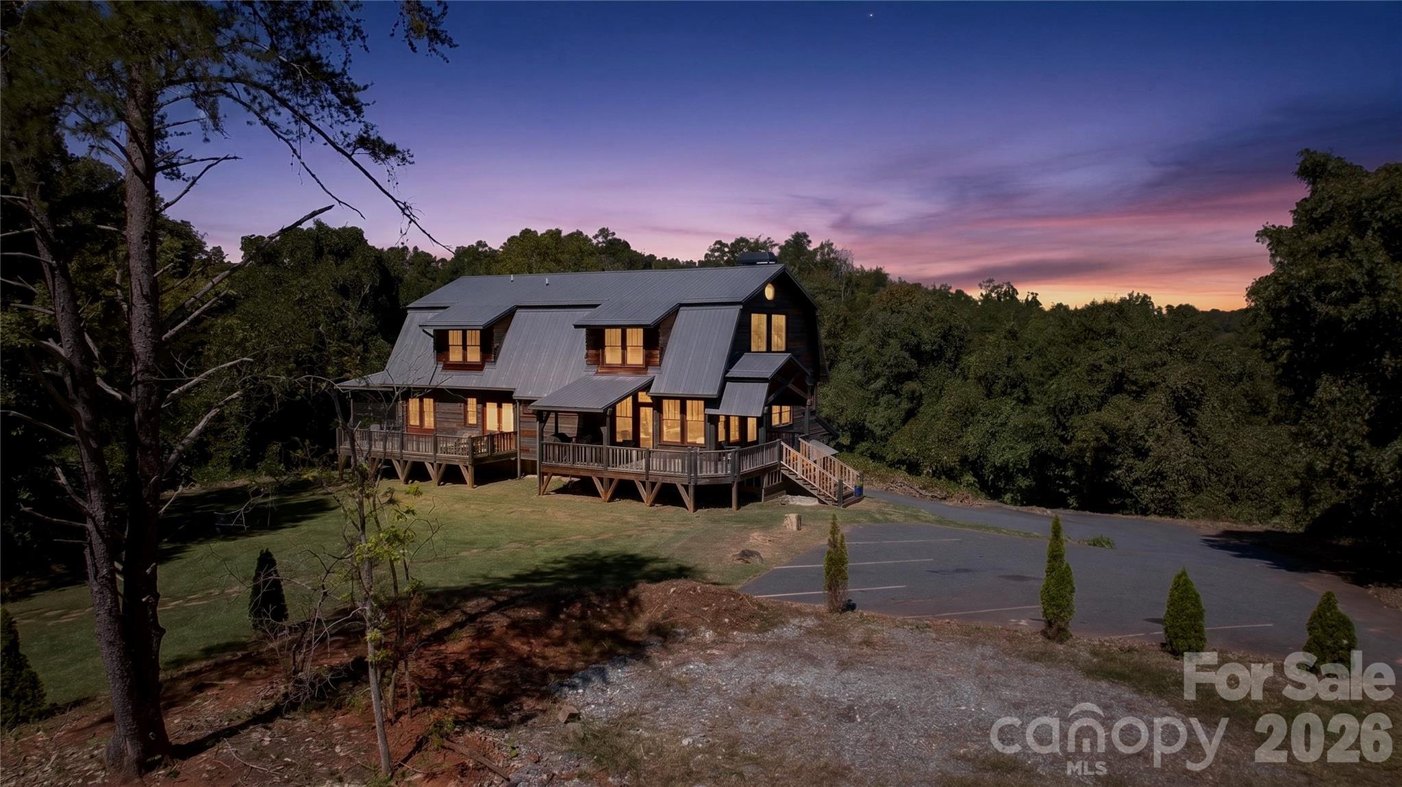 Welcome to Multi-Generational luxury living in Tryon’s Horse Country, located less than 5 minutes from Tryon International Equestrian Center and local vineyards. This 2020 built home situated on over 3.5 private acres,  features 4 bedrooms and 3.5 bathrooms, including a primary suite on the main floor and a private office. The heart of the home is a chef's kitchen featuring an 18-foot island designed for entertaining and commercial-grade stainless steel appliances, including a Viking Professional gas range and a Frigidaire Professional refrigerator and freezer. The property includes surround sound throughout the home and a large bonus room. Upstairs features a spacious loft, 3 additional bedrooms, and a shared Jack-and-Jill bathroom.The property also includes a secondary living area, accessible via its own exterior entrance or from inside the main home. This space includes one bedroom, one full bathroom, its own kitchen, and a separate laundry room. The garage spans the entire square footage of the first floor, offering 3 tandem spaces fitting up to 6 vehicles and an additional garage office. This space has extra room that could easily be converted to additional living area. Outdoor living features a spacious screened-in porch, an additional porch overlooking the private backyard, and a large stone firepit.