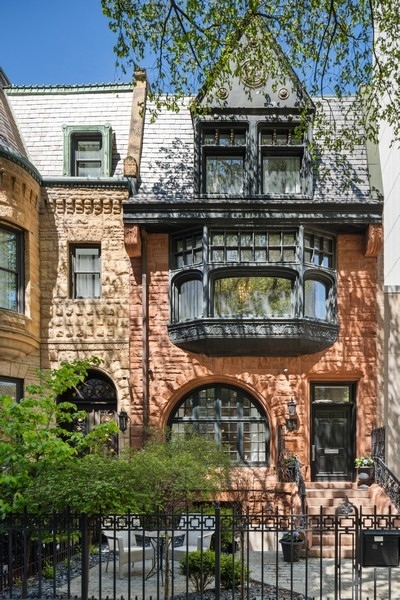 Quintessentially old Chicago on the outside and exquisitely modern on the inside, 34 E. Bellevue Pl. is a flawlessly renovated 5 bed/5.5 bath, 6500-square-foot, three-story single family home in the Gold Coast with a fully finished basement and three outdoor spaces including a roof deck. Located on a distinguished residential street just one block from the lakefront, an award-winning, luxury real estate developer executed the custom design and build to include world-class fixtures and finishes throughout - and an innovative program for contemporary, city living. The main level stuns from moment one, beginning with an open-concept living and dining room with high ceilings and espresso-hued, hand-scraped hardwood floors. Beyond lives a gorgeous chef's kitchen with custom cabinetry, professional-grade appliances, a large marble island that seats up to six, a butler's pantry and a breakfast space. The kitchen links to both a 24' x 6' side deck and a luxe family room with illuminated built-ins, a gas fireplace, and access to the home's 18' x 21' back deck that sits above its two-car garage. Upstairs, the second level presents a spacious, secondary bedroom with a large en-suite bath with soaking tub, and a spectacular primary suite with a sitting area and fireplace, a custom double walk-in closet, and a spa-worthy, marble en-suite bath with dual vanities, a soaking tub, and a steam shower. Plus, there's also a third level with a second family room with fireplace and wet bar, two additional bedrooms with walk-in closets, and a 16' x 32' roof deck with partial pergola for shade. But there's more. This home's basement level features a third family/media room with yet another built-in refreshments bar, a designer laundry room, two additional bedrooms including an en-suite bedroom for guests or an au pair, and two mudrooms with maximized storage. Additional design details include custom millwork throughout, embedded LED and statement lighting, and designer window treatments. Additionally, rare to find attached garage parking. One block from Oak Street Beach and a short stroll to first-class shopping and dining along Oak Street and the Mag Mile, not to mention fabulous parks, 34 E. Bellevue Pl. is a one-of-a-kind, custom single-family home for the discerning homebuyer.