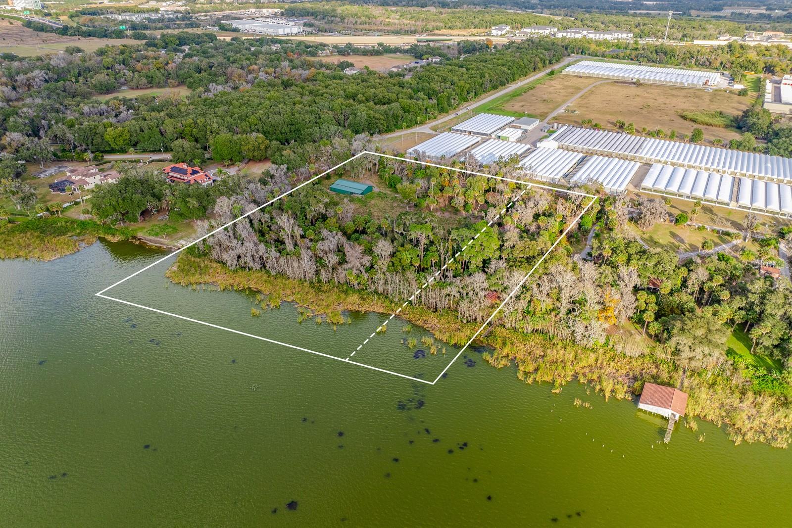 Nearly **8 ACRES** of prime **LAKEFRONT** land on **LAKE APOPKA**, offering a rare opportunity to create something truly special! This expansive property is made up of two separate parcels – one approximately 2 acres and an adjoining 5.76 acre lot – providing flexibility, privacy, and long-term potential. A large 5-car stall/metal building, recently installed on a solid concrete pad, is already in place on the larger parcel, adding immediate value and versatility for storage, workshop use, or future plans. Power has been brought to the front of the property and is ready for connection, and wetland studies have already been completed, helping pave the way toward your next steps. Surrounded by mature trees and natural beauty, the land offers peaceful water views and direct access to Lake Apopka, creating a setting that feels private and serene while still being incredibly convenient. Located just minutes from SR 429 for easy access to shopping, dining, recreation, and everything Central Florida has to offer. Whether you envision a dream waterfront estate, a smaller private retreat, or a unique multi-use property, this is a rare chance to own a personal sanctuary on Lake Apopka! Call today for more information and schedule a tour! **Seller may consider buyer concessions if made in an offer**