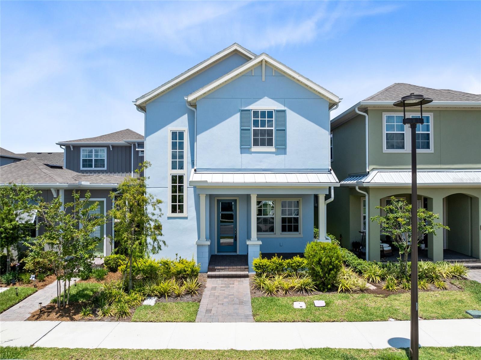 One or more photo(s) has been virtually staged. This stylish 4-bed, 3.5-bath home with a full 1-bed, 1-bath garage apartment is located in the heart of Lake Nona’s most sought-after community.

From the welcoming blue exterior and covered front porch to the designer interior finishes, every detail has been thoughtfully curated. Inside, 10’ ceilings, 8’ doors, and an open layout create an airy, modern vibe. The chef’s kitchen is a true centerpiece—featuring a navy and white two-tone palette, quartz countertops, designer tile backsplash, stainless steel appliances, and a spacious island with seating.

The open living and dining spaces flow seamlessly, filled with natural light and ideal for entertaining.

Upstairs, the owner’s suite feels like a spa getaway, complete with dual vanities, quartz counters, a sleek frameless glass shower, rain head, and beautiful natural light. Two additional bedrooms, a full bath, and a versatile loft complete the second floor.

Out back, enjoy your private courtyard-style patio—perfect for relaxing or outdoor dining. The detached garage apartment includes its own kitchen, living space, bedroom, and bath—great for guests, multigenerational living, or rental income.

Laureate Park isn’t just a neighborhood—it’s a lifestyle. Dive into resort-style living with access to the Aquatic Center, LP Fit gym, scenic parks, and over 44 miles of trails. Ideally located in Lake Nona, you're just minutes from Medical City, the VA Hospital, Nemours, top dining, shopping, and the Lake Nona Town Center. Enjoy quick access to major highways, Orlando International Airport, the USTA National Campus, and world-renowned theme parks and beaches. This home offers the perfect blend of luxury, space, and community. Come experience elevated living—schedule your private tour today!