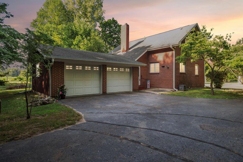 This beautiful 2-story home nestled on a private, wooded 1.7-acre serene setting, has mature trees and a peaceful countryside ambiance. Originally built in the 1930s and thoughtfully renovated, this mostly brick exterior residence offers 1,700+ sqft of finished living space with timeless charm.The spacious, open-concept living area with vaulted ceilings, stunning hardwood flooring, and views to the upper level. The main floor also includes a large primary bedroom, two full baths, laundry area, and French door access to a spacious rear yard deck, perfect for entertaining or relaxing amidst nature.Historically significant as the former Hubbard School (1854-1924), this home blends historic character with modern updates.  Close to shopping, and interstate highways. Hurry it will not last!