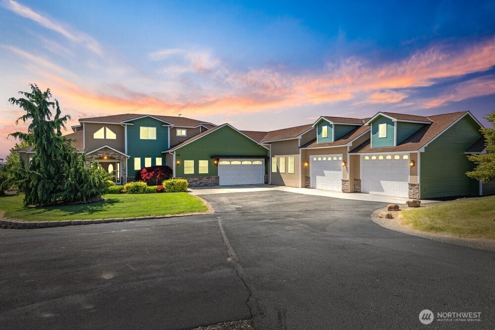 Experience the perfect blend of luxury, space, and recreation on this stunning custom-built estate situated on 2.26 private acres with sweeping territorial and mountain views. Offering 5,799 total square feet, including 3,729 square feet of living space, this home features 4 bedrooms, 3 bathrooms, a dedicated office, expansive entertaining areas, and a partially finished basement with framing already in place for future window additions—ideal for expansion, guest quarters, gym, or theater room. Inside, you’re welcomed by soaring ceilings, a grand staircase with custom iron railing and quality finishes throughout. The spacious living room features tray ceilings, large windows capturing surrounding views, and a stunning stone fireplace centerpiece. The kitchen was designed for gathering with abundant cabinetry, center island, custom lighting, and seamless flow into the dining and living spaces. A separate game room with full bar creates the perfect setup for entertaining. Outdoor amenities are equally impressive with an expansive Trex deck, built-in BBQ kitchen, pergola-covered seating areas, hot tub, custom fire pit with seating below the deck, and a fully fenced sports court. The attached shop features three oversized bays connected to the 2-car garage, offering exceptional space for vehicles, boats, RVs, storage, toys or projects. This is a rare opportunity to own a one-of-a-kind property that combines upscale living, recreation, shop space, and privacy with incredible views