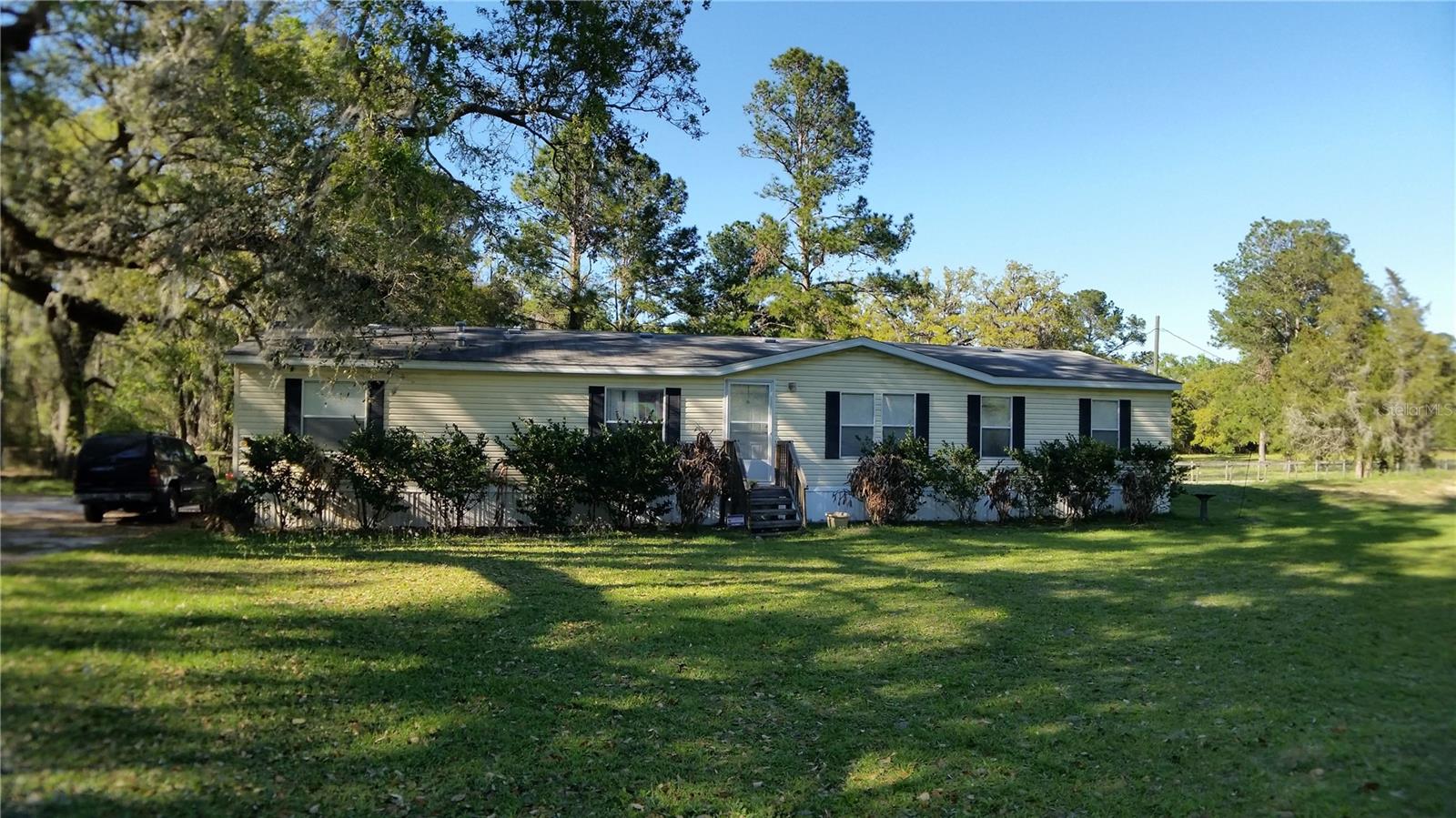 20 Acre parcel green belted, fenced and cross fenced with approximately 7 paddocks and pastures.  27 X 66 3 bedroom 2 bath manufactured home on property in need of many repairs.  Property value is in the 20 beautiful acres with pond, hurricane proof 72 X 30 barn with 2160 square feet constructed with steel I beams, steel purlins and steel trusses.  Full 2 X 8 cut pine siding with added 72 X 20 covered seven stall stable area with 1440 square feet. 30 X 20 Lean-to 600 square feet area.  20 acres with rolling hills and mature oak trees and livestock pond adorn the beautiful landscape.  Property is green belted and has an AG exemption ready for your livestock, horses and more.  Several out buildings adorn the property that can be utilized for your unique purposes.  All situated only 2.2 miles from Highway 41, approximately 5 miles from the Suncoast Expressway and only 3.5 miles to Culbreth Road. A perfect piece of paradise all situated in an area of development, minutes away from amenities with all the privacy.  Call for your private showing today!
