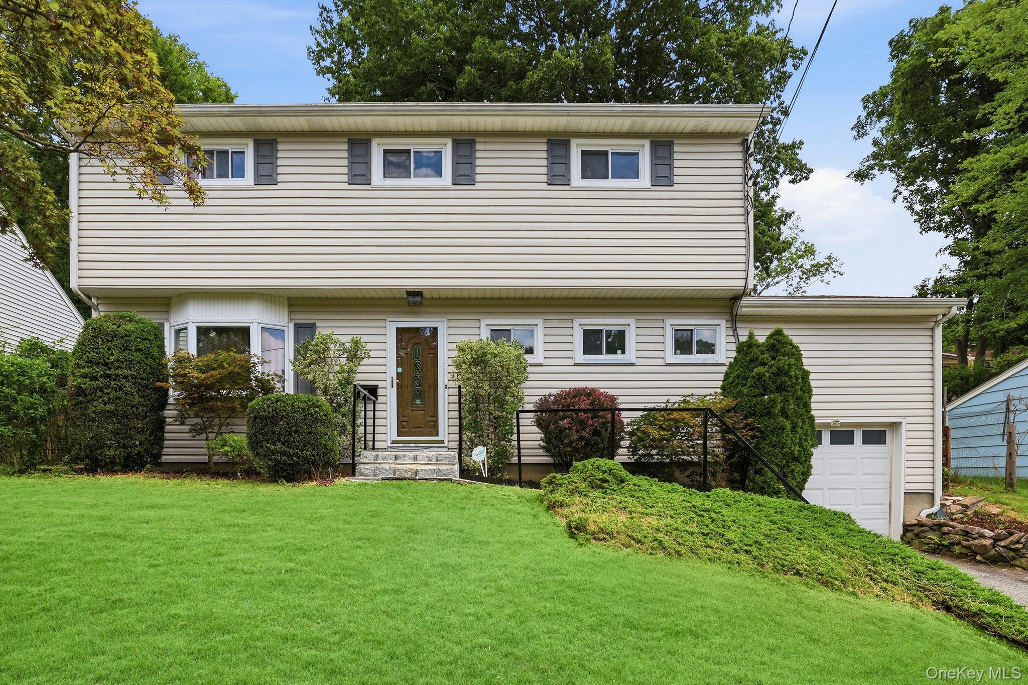 Welcome to this inviting split-level home, ideally located just minutes from vibrant downtown Mount Kisco. Offering 3 bedrooms, 1 full bath, and 1 half bath, this home combines comfort, functionality, and opportunity. Freshly painted throughout, featuring recently refinished floors and an updated half bath, the interior provides a bright, move-in-ready canvas for you to add your own personal style.The sun-filled main level offers an easy flow between the den, dining room, kitchen, and spacious living room. The living room impresses with soaring ceilings, oversized windows that flood the space with natural light, and sliding glass doors that open to the backyard perfect for indoor-outdoor living and entertaining.Upstairs, you’ll find three well-proportioned bedrooms and a full hall bath, providing comfortable accommodations for family or guests. Outside, the private backyard offers plenty of space to relax, garden, or host gatherings. Completing the home is a convenient one-car attached garage.Perfectly situated near shopping, dining, parks, schools, and Metro-North, this home offers an exceptional combination of location, comfort, and potential. Don’t miss the opportunity to make it yours!