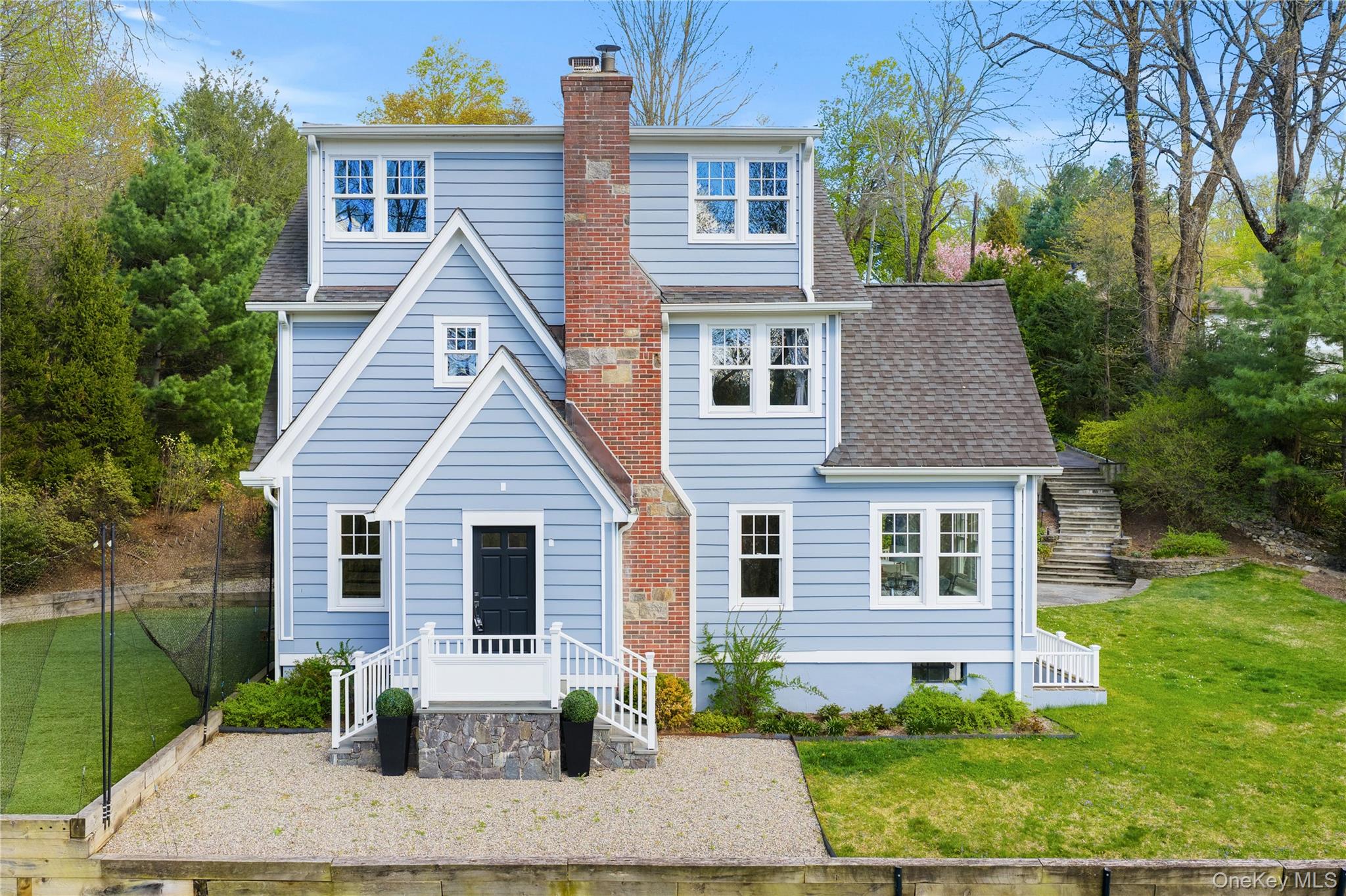Classic 1920 Colonial brimming with vintage charm and modern updates, ideally located on a desirable cul-de-sac just a short walk to town. This beautifully maintained 4/5-bedroom home features 2 renovated full baths plus a new powder room, a sparkling white renovated kitchen with floor to ceiling cabinetry, stainless steel appliances-Sub Zero, Miele, & Viking and a generous eat-in area with door to an expansive slate patio. renovated baths throughout. Gleaming hardwood floors, graceful architectural details, a cozy fireplace add timeless appeal.  The light-filled formal living room and dining room offer gleaming oak hardwood floors, crown molding and many windows. The adjacent family room or home  office has windows on three exposures. The second floor features a primary suite with renovated full bath and walk-in closet plus two additional bedrooms and a renovated hall bath. The third floor offers a large bedroom, and an additional playroom/guest/office, and oak floors throughout. Set on nearly an acre (.89) of landscaped grounds with a turfed play area and flat yard, this home offers comfort and convenience inside and out. New Marvin windows, updated mechanicals, gas heat, sewer, and 3-zone heating with central air ensure year-round efficiency. Ample storage in both basement and attic, plus excellent curb appeal, a freshly painted interior & exterior, low taxes, and a prime walk-to-town location make this property an exceptional find.