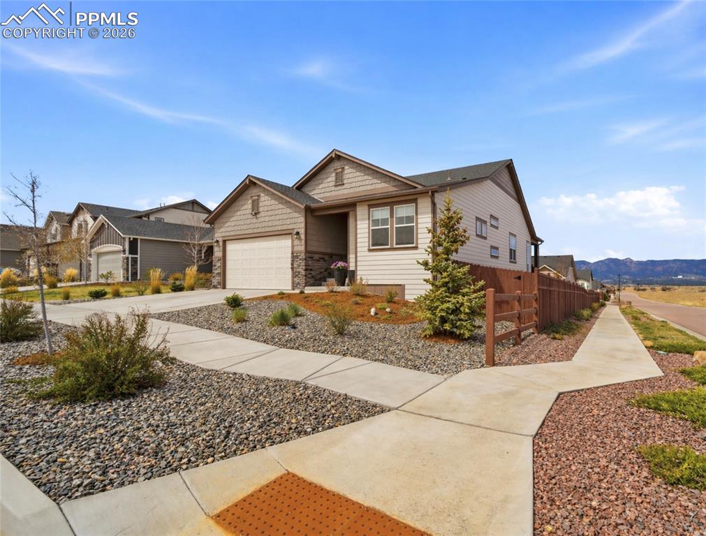 Look here first where the deck, the views & the lifestyle all come together in a quiet District 20 setting * Modern in design this home offers true main level living with an open concept layout, 8 foot doors & high ceilings that create an airy, inviting feel * Great room is anchored by the fireplace w/ custom tile & ceiling fan, enhanced with added windows for abundant natural light and VIEWS * Dedicated, spacious dining space * The extended kitchen is built for both everyday living & entertaining with a center island w/ solid surface tops, dedicated coffee bar, gas cooktop & high-end KitchenAid appliances all complemented by under cabinet lighting, soft close cabinetry / drawers, breakfast bar & stylish upper & lower transom windows * Main level primary suite offers a private retreat with a spa inspired bath featuring dual, raised vanities, dual shower heads, tile flooring & spacious walk in closet * Step outside to a covered composite deck with Trex style flooring that truly becomes the destination, capturing expansive views including the Air Force Academy & Pikes Peak, while the fully fenced backyard offers gates on both sides, sprinkler system in front & rear, large patio area ideal for outdoor living & entertaining * Garden level basement is filled with natural light & designed for fun with a step behind wet bar including upper cabinetry, counter seating, wine storage & beverage refrigerator * Large recreation area to include billiard space is a great retreat * Large storage area & additional under stair storage a bonus * 2 Additional bedrooms with ample closet space (one is a walk-in), serviced by a full bathroom with dual raised vanity & tile flooring * Functional mud room with utility sink & camera system above the garage which is an extended 2 1/2 car with upgraded epoxy flooring, custom paint, high-end lighting & garage service door to back yard * Rare opportunity to own a home that balances everyday livability, modern flair with standout features, WOW!