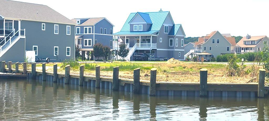 Looking for breathtaking views of the Chincoteague Bay, a front row seat to rocket launches and a protected canal where you can dock your boat 20 feet from your back door? This large cleared lot with BRAND NEW BULKHEAD has 105 feet of waterfront facing the Chincoteague Bay and is located in a quiet cul de sac in the amenity rich community of Captains Cove, featuring 2 outdoor pools, 1 indoor pool with a variety of activities, fitness room, golf, community boat ramp, dog park, tennis, pickleball, and a Marina Club Restaurant that features live entertainment. Captains Cove is located a short ride from Chincoteague Island, VA and Ocean City, MD. This lot has water and sewer availability and NO BUILDER TIE-IN, so take your time to design and build your waterfront dream home.