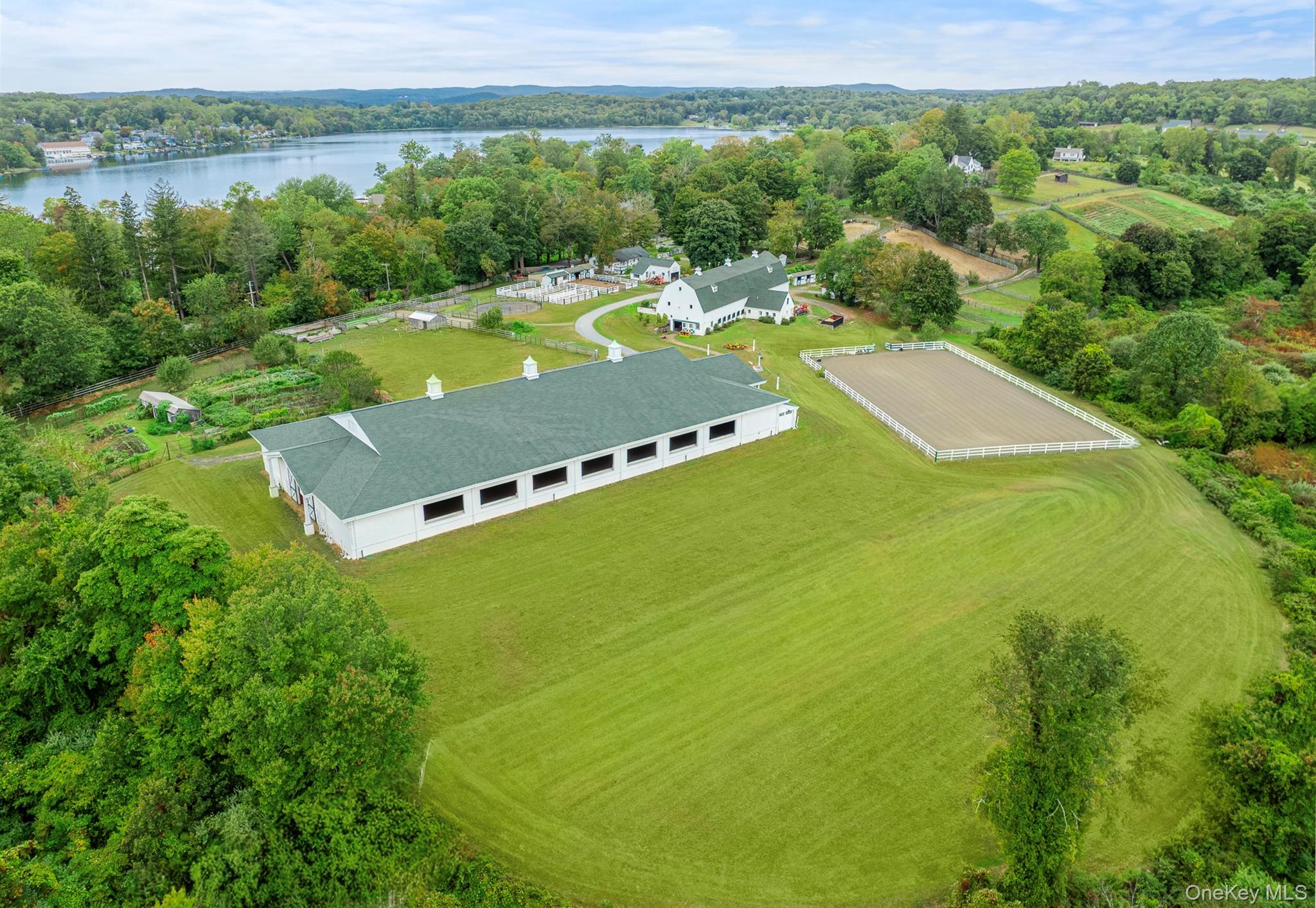 AVALON FARM. A phenomenal, state-of-the-art 23+ acre equestrian boarding facility with 25 stalls in the heart of North Salem. Completely renovated 19th century main barn with 18 rubber mattress stalls, 2 heated wash stalls, multiple tack rooms, office, powder room, laundry, and incredible upper hayloft with barreled ceiling. 4 and 3 stall guest barns with own tack and feed room. One of a kind 100 x 200 indoor riding arena with Lawton Adams TravelRight footing, safety soft impact kick boards, no avalanche pitched roof, ventilation system and 12 automatic garage style glass doors that with a push of a button, can be converted to a covered ring in the summer. Climate-controlled viewing lounge and powder room with full audio speaker system for indoor. 120’ x 200’ outdoor riding arena with Lawton Adams footing. All traffic areas feature Eco Raster ‘no mud’ system. Heated path from main barn to Indoor Ring. Numerous rolling grass turnout paddocks with water and electricity. Medical paddocks. 1 bedroom and 2 bedroom + office staff apartments.  Large 4 bay garage for equipment storage. High end renovation of 3 bedroom, 2.5 bath colonial cottage with covered outdoor spa entertaining area. The property abuts the 58 acre North Salem Open Land Foundation's Gaymark Preserve with direct access to the NSBTA Trail system. The property is also a biodynamic farm and currently produces an incredible array of organic fruits, vegetables, milk, and eggs. Generator with 5000 gallon underground propane tank supports farm buildings. This facility features all of the amenities the accomplished professional could desire while being located less than 3 miles from International Show jumping venue Old Salem Farm and other top shows. Close proximity to NYC, airports, highways and excellent restaurants. Located in an Agricultural District. Delightful farm to suit all members of your family. Agricultural Exemption Savings of $47,317.21. Total taxes are $25,224.31