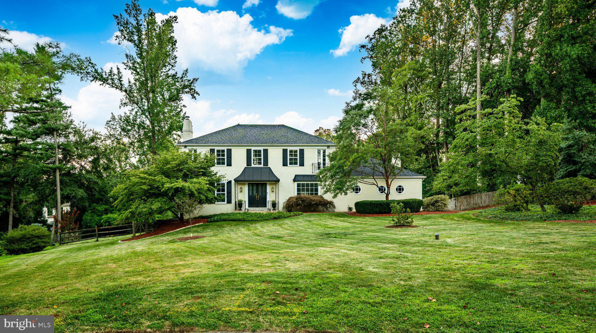 Welcome to 4 Denford in Newtown Square’s sought-after Greene Countrie neighborhood, set on a quiet cul-de-sac on almost an acre of grounds. This French Colonial pairs a polished center-hall design with a resort-style outdoor space including a pool and hot tub with waterfall, framed by established landscaping, and a fully fenced yard. The home offers 4 bedrooms, 3.5 baths, light-filled rooms, hardwood floors across the first and second levels, a newly finished daylight walk-out lower level, and a balanced floor plan with defined spaces for dining, gathering, working, relaxing, and hosting. The paver walkway takes you to the grand double door entry, which opens to a classic foyer. Upon entering, the dining room is finished with crown and chair rail moldings, and the expansive living room offers a neutral palette, gas fireplace, and timeless proportions for formal or casual use. At the rear, the spacious great room brings volume and warmth with vaulted ceilings, rustic wood beams, a wet bar, and sliding glass doors to the deck, pool and outdoor area. Off the sunlit dining room with bay windows, the newly refreshed eat-in kitchen features white cabinetry, stainless steel appliances, a granite island, herringbone marble backsplash and a new porcelain tile floor, open to the breakfast area, creating a central hub for everyday meals and weekend entertaining. Sliding doors open from the kitchen to the large deck, extending the living space outdoors for al fresco dining, morning coffee, or evenings overlooking the pool area and grounds. A family room off the kitchen adds a refined work, reading, or lounge space with triple windows, wainscoting, built-in shelving, and a gas fireplace. The laundry room is conveniently located on this level, the powder room, and attached 2-car garage keep the main level practical and efficient. Upstairs, the primary suite includes a spacious bedroom, walk-in closet, and updated en-suite bath with a vanity and shower with glass enclosure. Three additional spacious bedrooms offer hardwood floors and outfitted closets, and two feature large windows with Juliet balconies for added architectural character. The newly finished lower level expands the home with new LVP flooring, a neutral full bath, an office/bedroom with egress window and closet, and a theater room with projector, creating flexible zones for media, guests, projects, hobbies, fitness, storage, or a fifth-bedroom setup if desired. Crown & wainscoting, arched openings, built-ins, exposed beams, a wet bar, Juliet balconies, and two gas fireplaces add depth and character across all three finished levels. Outdoor living is easily accessed from the breakfast room or the great room and is a spectacular feature, with a heated in-ground pool, hot tub with waterfall feature, large deck for dining and lounging, generous lawn area, mature trees and plantings, and room for seasonal entertaining. The almost acre of ground gives the pool, deck, hot tub, and yard room to breathe, while plantings soften the setting and add a sense of privacy. Recent updates include a newly finished lower level, a refreshed and updated gourmet kitchen, HVAC (2024), newer roof (2021), giving the home meaningful system and exterior improvements alongside its classic design details. The location adds excellent daily convenience and appeal, with Whole Foods Market and WFM Coffee Bar at Ellis Preserve 1.4 mi, Saw Mill Park 0.5 mi, Skunk Hollow 0.6 mi, CVS about 1.4 mi, Newtown Public Library nearby, and dining, retail, fitness, and services throughout Ellis Preserve and Newtown Square. Regional lifestyle anchors include Chanticleer Garden in Wayne, multiple Parks, downtown Wayne, Aronimink Golf Club, and Main Line destinations, all supporting a polished suburban setting with quick access to shopping, restaurants, parks, schools, and local attractions. School anchors include Culbertson Elementary School 0.8 mi, and award wining Private schools.