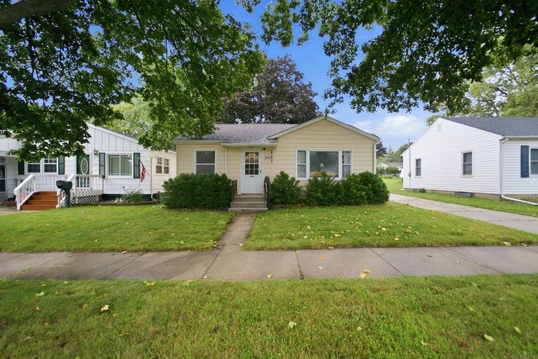 Step into this quality, well-maintained three-bedroom, one-bathroom home filled with character and thoughtful updates. Beautiful original hardwood floors have been meticulously cared for, while arched doorways add timeless charm throughout the main level. The main floor offers comfortable, easy living with three bedrooms, a welcoming living room, kitchen, and a newly renovated bathroom all conveniently located on one level. The lower level provides additional living and recreational space, including a spacious rec room currently set up as a theater room, laundry area with washer and dryer included, ample storage, and a roughed-in shower offering potential for future improvements. Outside, the 24’ x 24’ two-stall detached garage provides plenty of room for vehicles, hobbies, projects, or additional storage, along with bonus space for even more flexibility. A concrete patio offers space to grill and relax! A charming home with well-cared-for original features, practical living spaces, and room to make it your own!