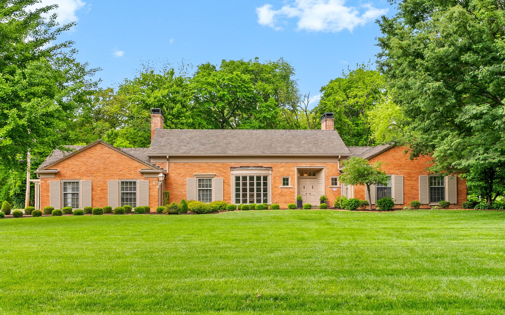 Exquisite 5BR, 3F/2H BA all-brick estate, fully renovated to perfection. Gourmet custom kitchen boasts a grand quartz island & wood-burning fireplace, complemented by a spacious utility room w/ extra refrigerator, dishwasher, & abundant storage. Sophisticated details throughout: tile roof with extra tiles, elegant wood parquet floors, marble flooring in entry & hallway, rich built-ins, gas fireplaces in living & primary suite, luxurious primary bath w/ custom cabinetry & expansive walk-in closet. Outdoor living dazzles w/ new stamped concrete patio, pergola, lush landscaping, & outdoor fireplace. Full unfinished basement w/ half bath & 2-car garage complete this rare gem.