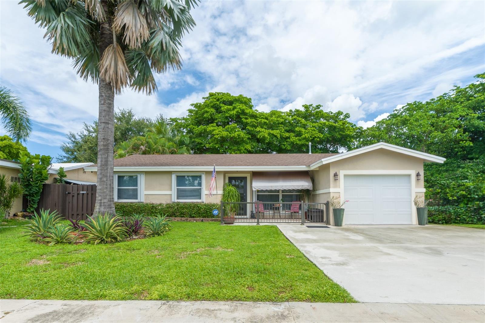 Welcome to the perfect place to call home! This charming 3-bedroom, 2-bathroom residence with a 1-car garage is ideally located in Sunrise, Florida—less than 30 minutes from Fort Lauderdale. Best of all, there are no HOA or CDD fees.From the moment you arrive, you’ll appreciate the home’s inviting curb appeal, well-maintained landscaping, and welcoming front porch. The hurricane-rated front door and garage door provide added peace of mind, while accordion hurricane shutters are available throughout the rest of the home.Inside, abundant natural light fills the living spaces. Ceramic tile flooring throughout most of the home offers both style and durability, making it especially convenient for pet owners. Ceiling fans are thoughtfully placed throughout, and the functional kitchen provides ample storage and an excellent layout for entertaining.The flexible floor plan includes three bedrooms, with one easily adaptable as a home office, craft room, or guest space. French doors open to a private, oasis-like backyard with no rear neighbors offering an exceptional level of privacy. The covered back patio features upgraded pavers and colorful shade coverings, creating a comfortable and inviting outdoor retreat.Two large storage sheds are included with the property, providing plenty of space for tools, equipment, and household belongings.This home’s location is truly hard to beat. It is less than a mile from Sawgrass Mills Mall, close to three Publix supermarkets, and near Welleby Park, which features a free splash park. You’ll also enjoy convenient access to the library, Civic Center, City of Sunrise Athletic Center, and a 669-acre regional park offering a variety of outdoor activities—including technical mountain bike trails, an RC model airplane airfield, and a premier public shooting complex with 100-yard rifle and pistol ranges, as well as archery facilities.With comfort, functionality, privacy, and convenience, this home truly has something for everyone. Schedule your showing today, this wonderful opportunity won’t last!All information is believed and deemed to be accurate, but is not guaranteed and should be independently verified by the buyer and the buyer’s agent.