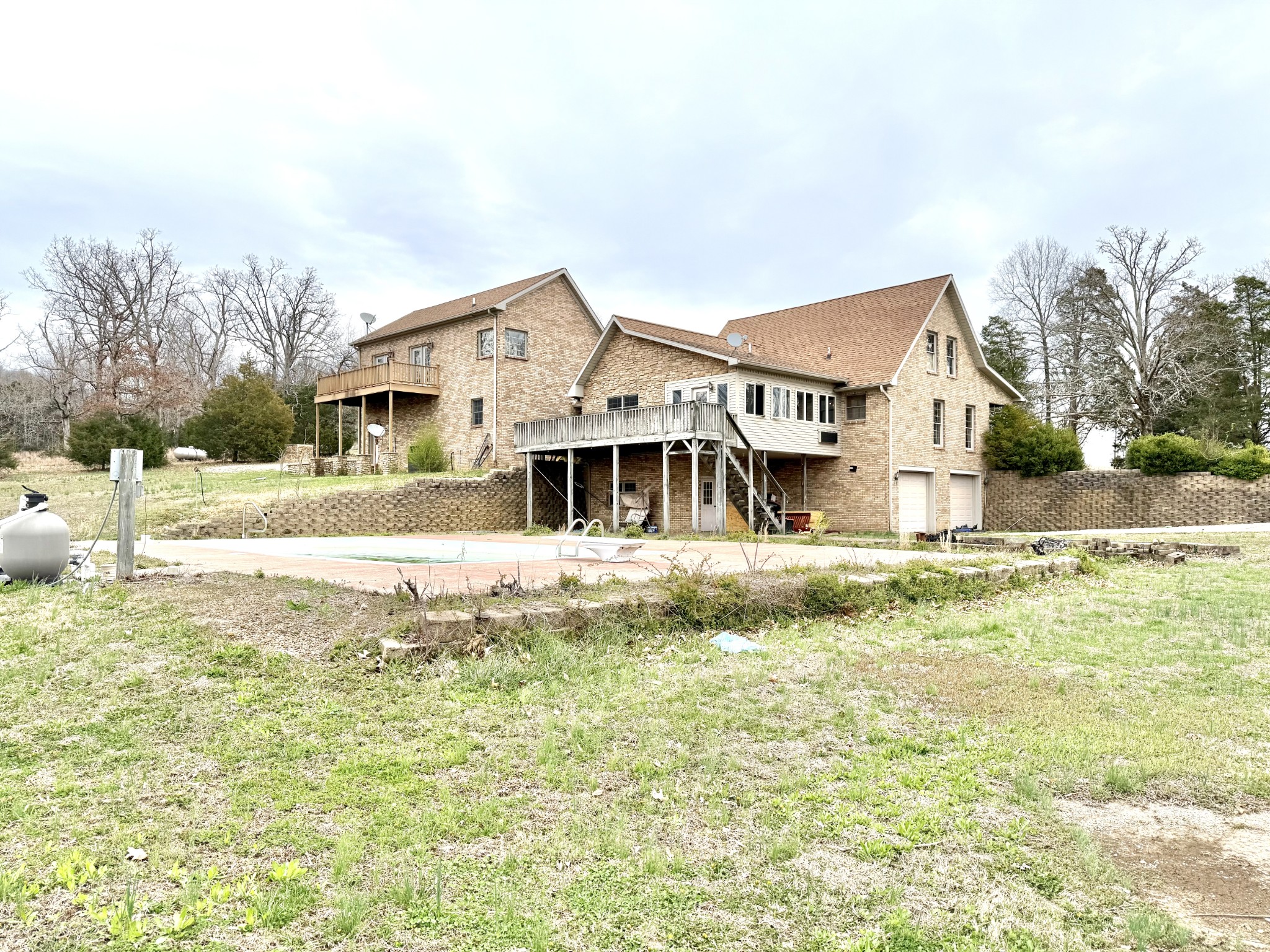 Secluded 70-Acre Retreat with Inground Pool & Abundant Wildlife! Escape to your own private oasis at 5005 Gracey Sinking Fork Rd! This secluded 70-acre property offers the perfect mix of luxury and nature, complete with an inground swimming pool and an abundance of wildlife, including deer, turkey, and rabbits. Inside, the spacious kitchen is a chef’s dream, featuring plenty of cabinets, an eat-around island, and open sightlines to the living area. The living room boasts a soaring stone fireplace and beautiful wood flooring, creating a warm and inviting atmosphere. With two primary suites, this home offers flexible living arrangements. The first master bedroom, just off the living room, provides a peaceful retreat, while the primary suite features an oversized bathroom with a jetted tub and a luxurious tiled shower with dual showerheads. Two oversize concrete workshops. If you’re looking for privacy, space, and modern comforts in a natural setting, this is the perfect home for you.