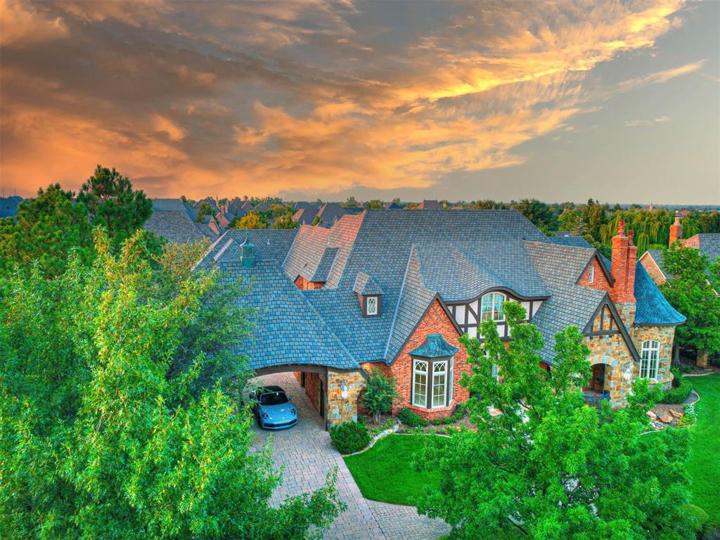 Step into luxury living at its finest in the prestigious Fairview Farm community, known for its prime location and top-rated school district. This exceptional home was custom-built by renowned home designer Brent Gibson, and the attention to detail is nothing short of extraordinary. The grand entry welcomes you with soaring ceilings, inlaid wood floors, and wide arched doorways. The foyers stunning architectural detail, including beams and an impressive staircase with hand-forged wrought iron, sets the tone for this remarkable home. The formal dining room boasts lovely herringbone floors, while the formal living room offers a unique circular sitting area with a vaulted dome ceiling and an elegant fireplace. The spacious family room is highlighted by a wood-beamed cathedral ceiling, light-filled windows, and a floor-to-ceiling fireplace. The huge chefs kitchen features a massive island, built-ins, and abundant storage, perfect for indoor and outdoor entertaining. The main level includes a master suite, guest suite, and a multi-purpose room that opens to the pool and outdoor living area. Upstairs, you'll find 4 additional bedrooms, 3 full baths, a large game room, and a flex room. The expansive outdoor space is a true retreat, featuring a resort-style pool, outdoor kitchen, and fireplace, perfect for entertaining. With too many amenities to list, this home is a rare opportunity to experience luxury living in one of the most sought-after communities in Edmond.