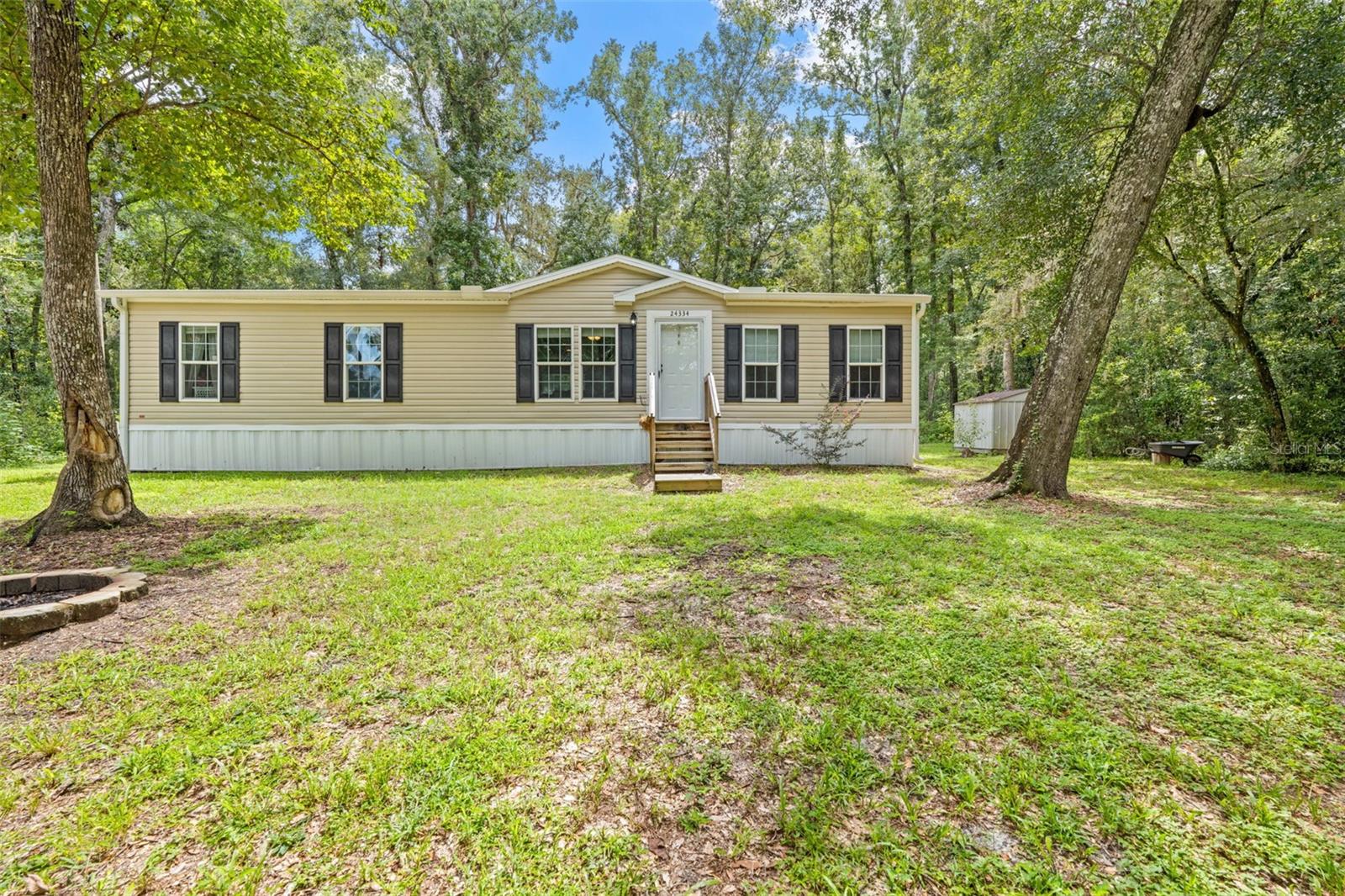 Welcome to your peaceful retreat in Brooksville! Nestled on a beautiful 1-acre wooded lot, this spacious 2020 manufactured home offers 1,560 square feet of comfortable living space, privacy, and a convenient open-concept design!Featuring 4 bedrooms and 2 bathrooms, the desirable split-bedroom floor plan provides privacy for the primary suite while keeping the additional bedrooms comfortably separated. The spacious kitchen features a center island and overlooks the living room, creating an inviting space for everyday living and entertaining.The home also features a new roof installed in 2025, providing added peace of mind for its new owners. This home is equipped with a deep well and whole home water filtration system and water softener! Outside, enjoy the serenity of your own wooded acre with plenty of space to relax, garden,  entertain, start a mini farm or simply enjoy the natural surroundings and wildlife! You can watch deer and other adorable wildlife stroll by, right from the kitchen window! A small storage shed conveys with the property, offering convenient additional storage.Built in 2020 and situated on a generous 1-acre parcel, this property offers the best of both worlds—comfortable modern living with the privacy and peacefulness of a wooded setting. Eligible for FHA, VA, USDA, and Conventional financing, subject to lender and property qualifications.If you're looking for space, privacy, and affordability in Brooksville, this one is worth seeing!