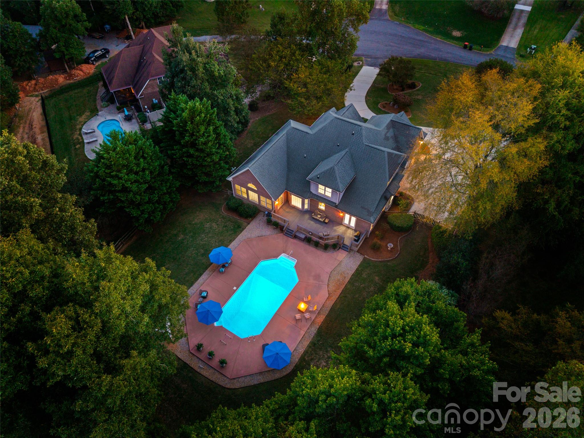 RARE FIND! Enjoy acreage, privacy, an in-ground pool, and no HOA, all in a convenient Lake Wylie location. Welcome to 131 Summerfield Court, a beautifully maintained 2-story home with 4 bedrooms, 3.5 baths, an open-concept design, and impressive ceiling design. Wood floors flow throughout the main living areas. The spacious kitchen features granite countertops, a tile backsplash, an island with a bar sink, an electric range, a pantry, a built-in desk, and a dining area with a bay window overlooking the pool. The spacious dining room features built-ins and a bay window. The great room features built-ins surrounding a see-through fireplace that connects to the office, adding warmth and character to both spaces. The light-filled sunroom exits to the large deck and offers tall ceilings and peaceful views of the backyard and pool. The main-level primary suite includes a walk-in closet, French doors opening onto the deck, and a private bath with tile flooring, a quartz double vanity, a beautiful tub, a separate shower, and a water closet. A half bath and laundry room with cabinets and a utility sink are also located on the first floor. Upstairs, you will find three additional bedrooms and a bonus room. One bedroom and the bonus room share a Jack-and-Jill bath, while an additional full bath completes the upper level. Outside, enjoy a large backyard, expansive deck, in-ground pool, irrigation system, and plenty of privacy. Enjoy the Lake Wylie lifestyle with convenient access to McDowell Nature Preserve, boating, fishing, parks, shopping, dining, and Charlotte, while coming home to privacy and serenity.