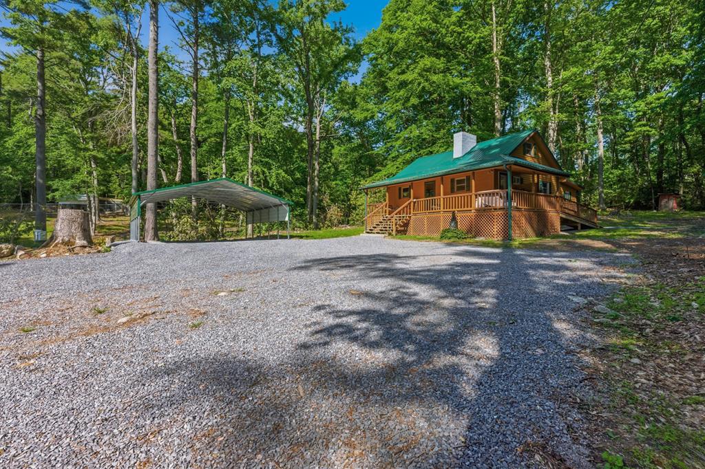 Located close to both Mount Rogers and Whitetop, this well-maintained cabin at 17609 Burnt Cabin Trail offers a private setting with close access to outdoor recreation and public lands. Positioned at the end of a dead-end road near national forest property, the cabin provides a convenient base for enjoying the surrounding mountain region and nearby recreational opportunities. The cabin includes 2 bedrooms and 1 bathroom and has been extensively renovated on the interior. Updates have been completed throughout the home while maintaining the character and functionality expected in a mountain property. A small addition expanded the total square footage and provides additional storage space along with a dedicated laundry room for improved convenience and utility.  The surrounding region is known for its proximity to public lands, scenic mountain views, trout streams, and outdoor recreation opportunities in Southwest Virginia. The property may serve as a full-time residence, seasonal retreat, or recreational getaway. The cabin features a practical open layout with comfortable living space suitable for year-round use. The end-of-road location offers a quiet setting while remaining accessible to nearby towns and services. The combination of renovated interior space, mountain location, and recreational access creates an unique opportunity.  Outdoor enthusiasts will appreciate the close proximity to hiking trails, hunting areas, fishing waters, horseback riding trails, and scenic mountain drives throughout Southwest Virginia.  Home is serviced by well water, wood heat/propane heat, electric appliances and has reliable internet!   Two pole barns on the property currently used for fire wood and parking.  Floor plans are intended as a general representation of the layout and may not reflect exact dimensions or details. Buyer/Buyer Agents to verify all information.