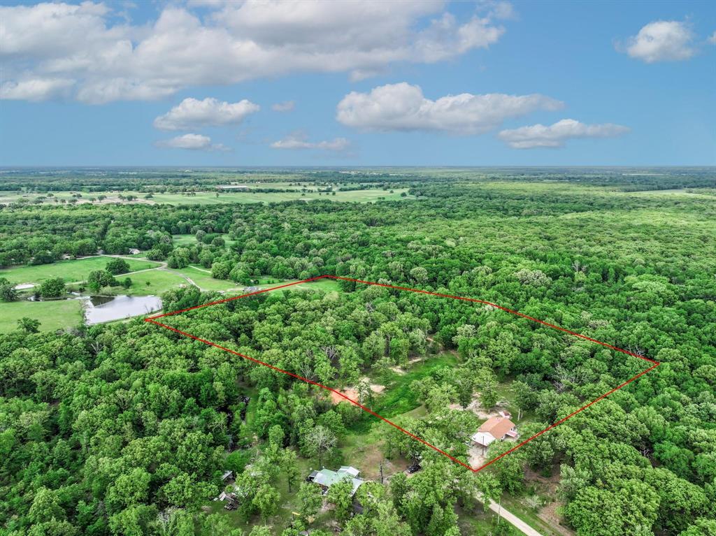 This cozy home sits on 9 acres nestled at the end of a county road. Inside, the vaulted living room comes with a fireplace and double ceiling fans with a semi-open floor plan. The kitchen includes stainless steel appliances, tile floors, a breakfast bar and a dining area. The split bedroom floor plan has 3 bedrooms and 2 full bathrooms. Bring your outdoor furniture and sit on the large front porch or back patio to enjoy the wooded views. A fenced backyard, storage buildings, raised garden area, and carport are added bonuses! Wooded trails are there for you to explore the acreage! You’ll find plenty of outdoor fun on this property in Hopkins County.