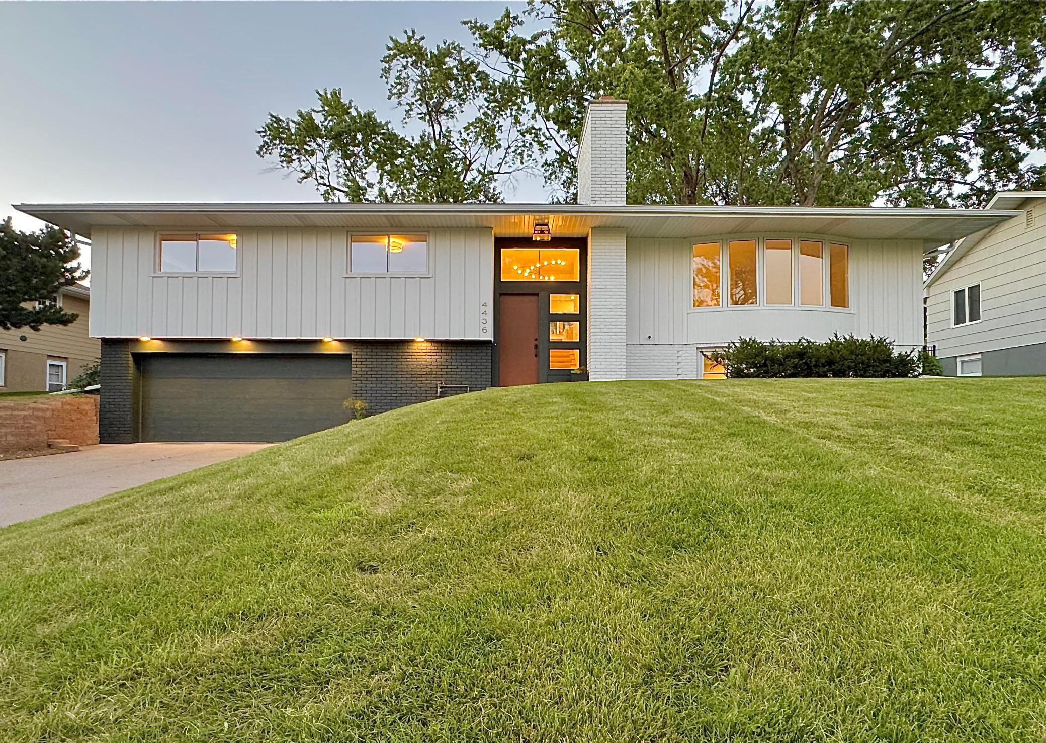 Completely renovated mid-century modern gem in Edina, minutes from downtown, walking distance to parks, dining, and shopping, with an easy commute to the Twin Cities.The main level features a new, open, enlarged kitchen with a 10-foot waterfall island, soft-close cabinetry, and quartz countertops. All-new appliances include a Bosch dishwasher, KitchenAid induction oven and refrigerator, and a Vent-A-Hood exhaust fan. Plenty of natural light through a large picture window. The kitchen connects to the living room, with front yard views and a wood-burning fireplace. The dining room sits off the kitchen with access to the new 28x15 backyard deck.Three bedrooms complete the main level, including a primary suite with a walk-in shower, tile surround, and walk-in closet. The second bedroom offers front and side yard views and a walk-in closet. The third bedroom includes built-in cabinetry. The main bathroom, new and enlarged, features tile surround and quartz counters.The lower level offers a family room with new carpet and memory foam pad, a 4 bedroom or flex room for a workout space or game room, a new 3/4 bath, and a laundry room with an LG washer/dryer. The garage connects via a mudroom.New plumbing, electrical, hardwood floors, and paint throughout, plus new windows, exterior doors, mudroom, water softener, garage door, gutters, downspouts, and drain tile/sump around the foundation.